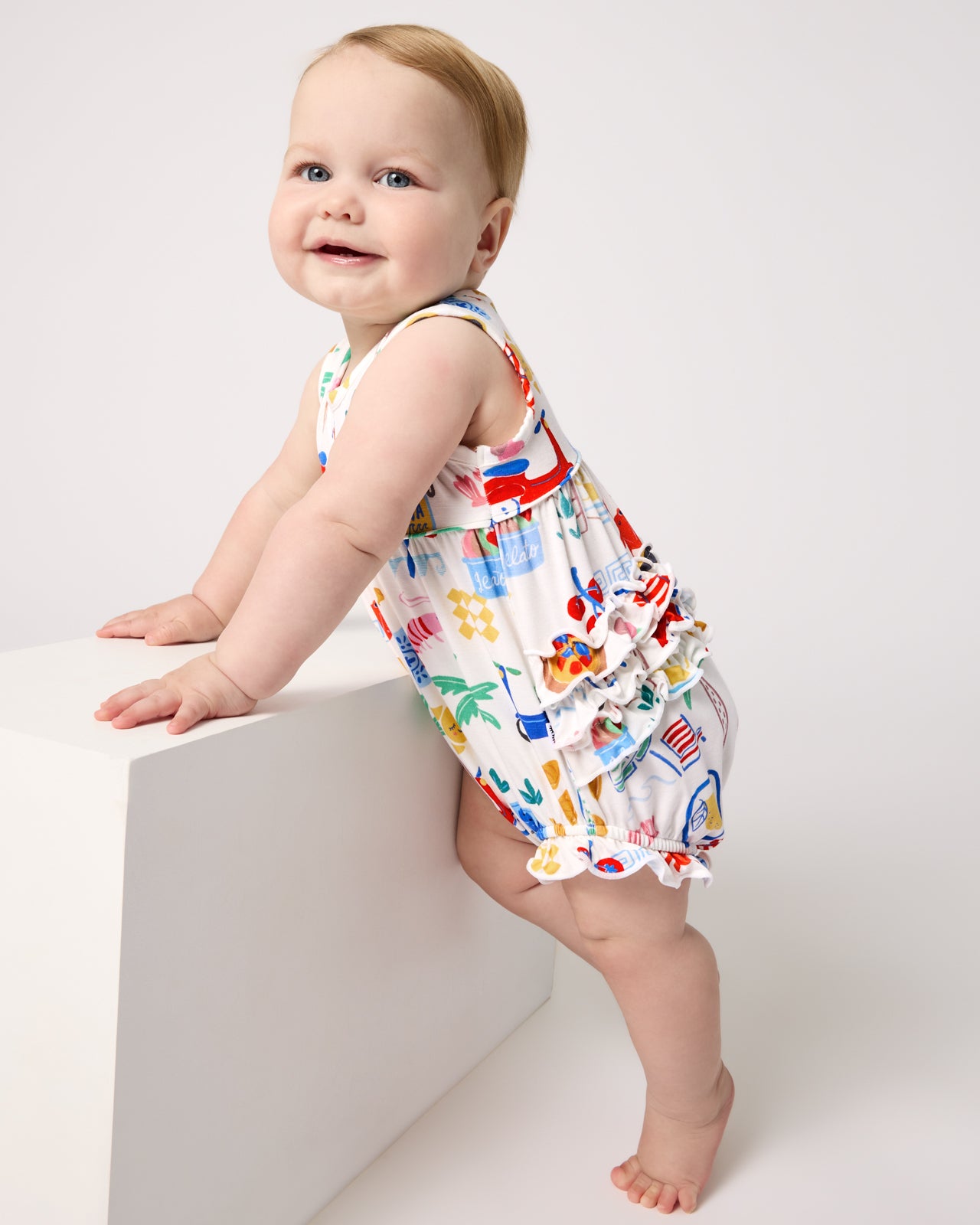 Standing baby wearing the Ciao Bella Bubble Romper