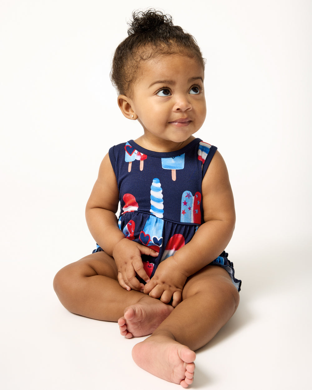 Sitting baby wearing the Sparkle Treats Bubble Romper
