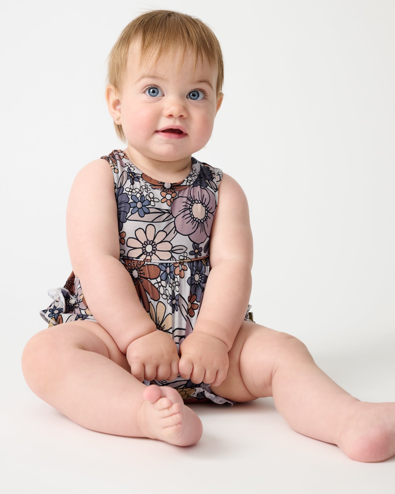 Sitting baby wearing the Wildwood Floral Bubble Romper