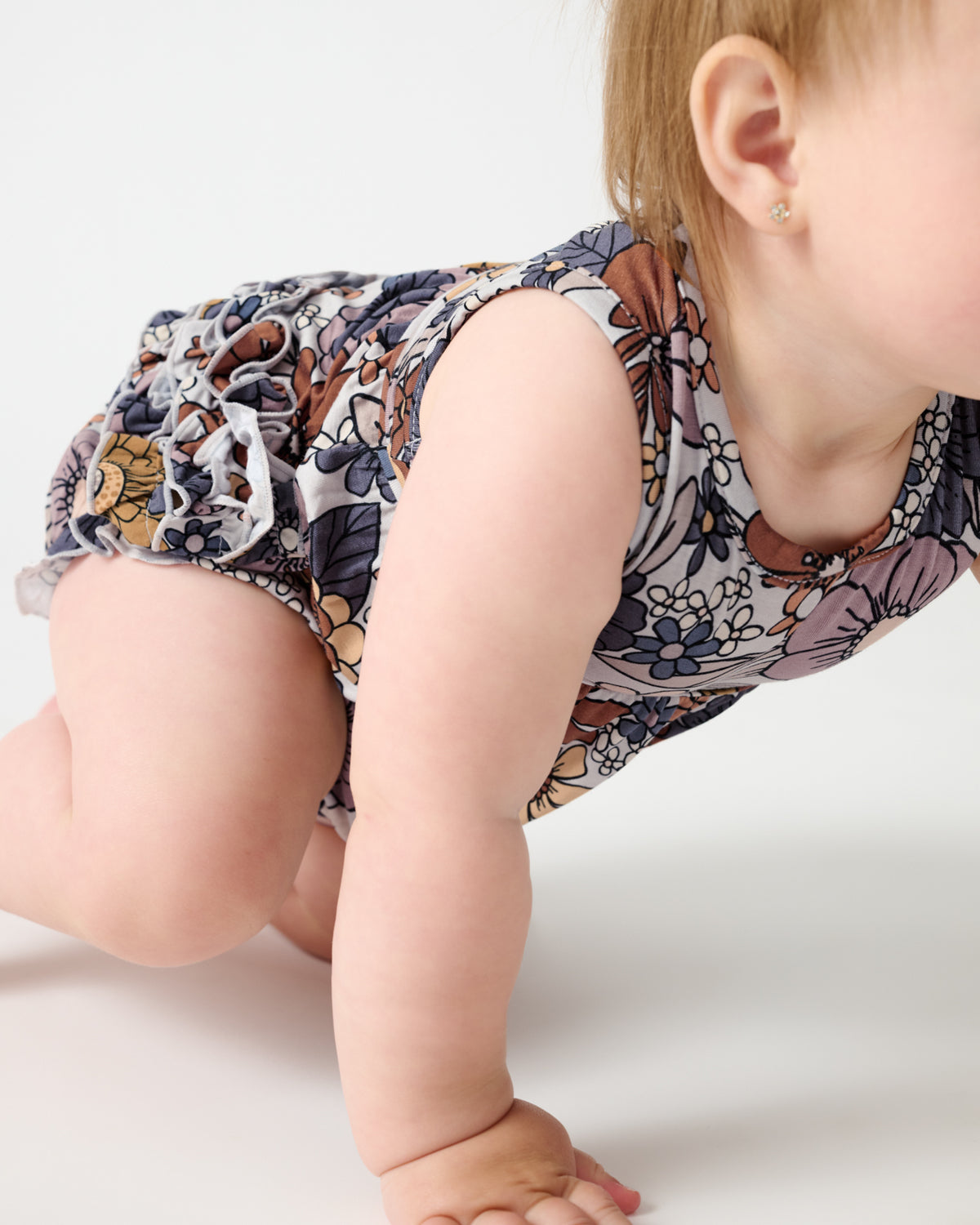 Crawling baby wearing the Wildwood Floral Bubble Romper