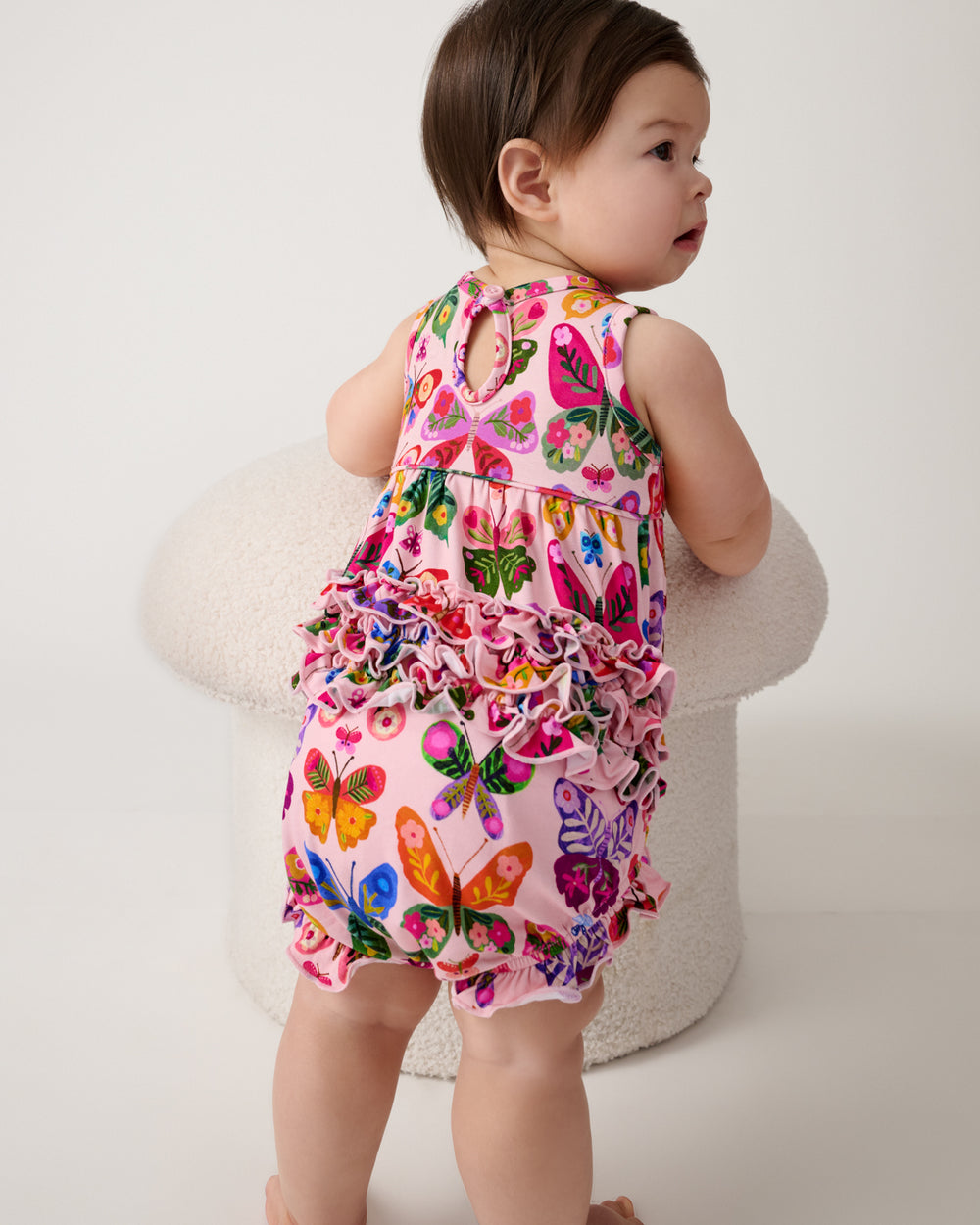 Back view of baby wearing the Flutter Garden Bubble Romper