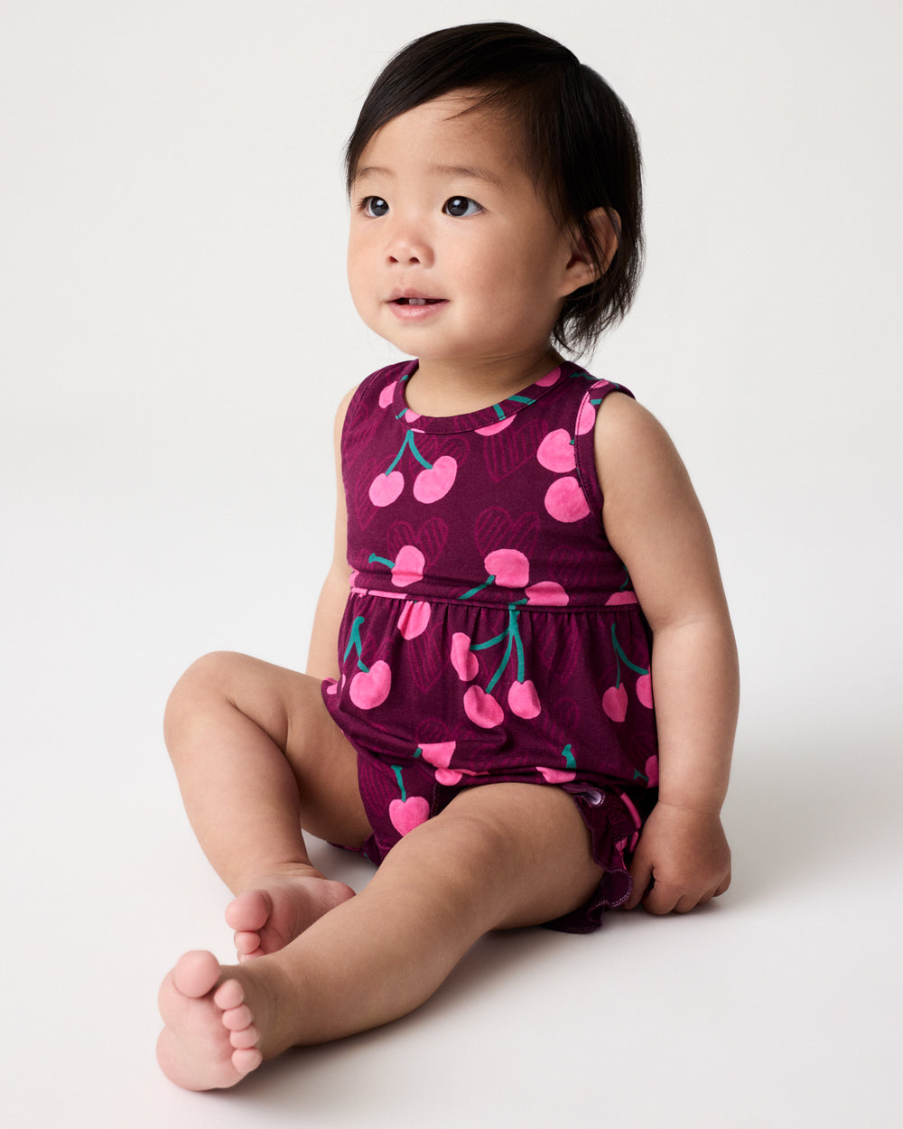 Baby wearing the Cherry Charm Bubble Romper