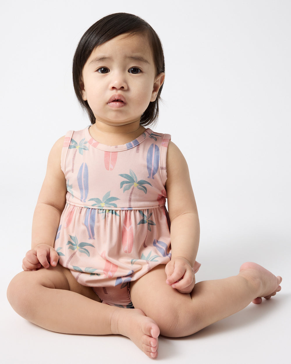 Sitting baby wearing the Palm Dunes Bubble Romper