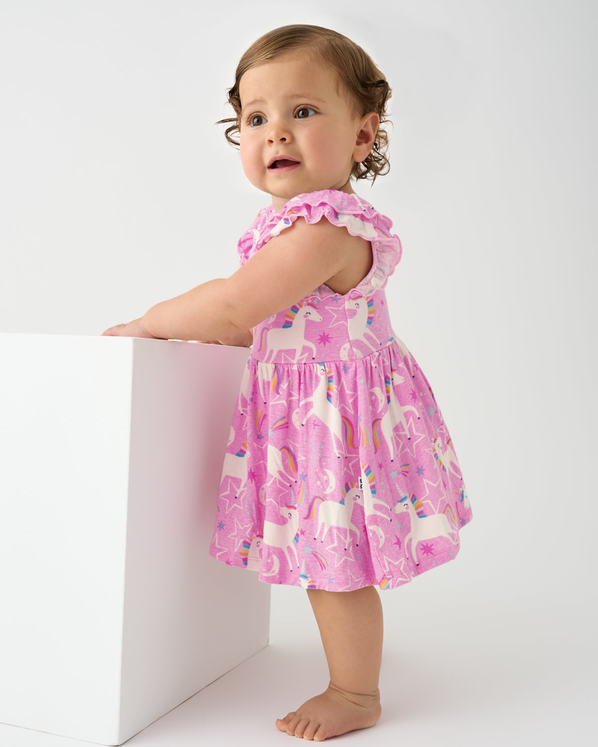 Standing baby wearing the Unicorn Dance Flutter Twirl Dress with Bodysuit