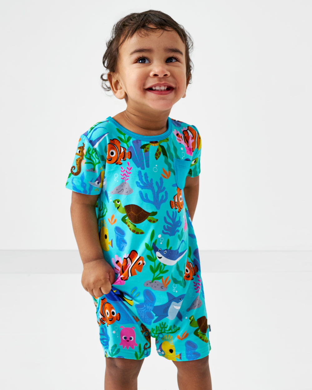 Close up of child wearing the Pixar Nemo's Reef Pocket Shorty Romper