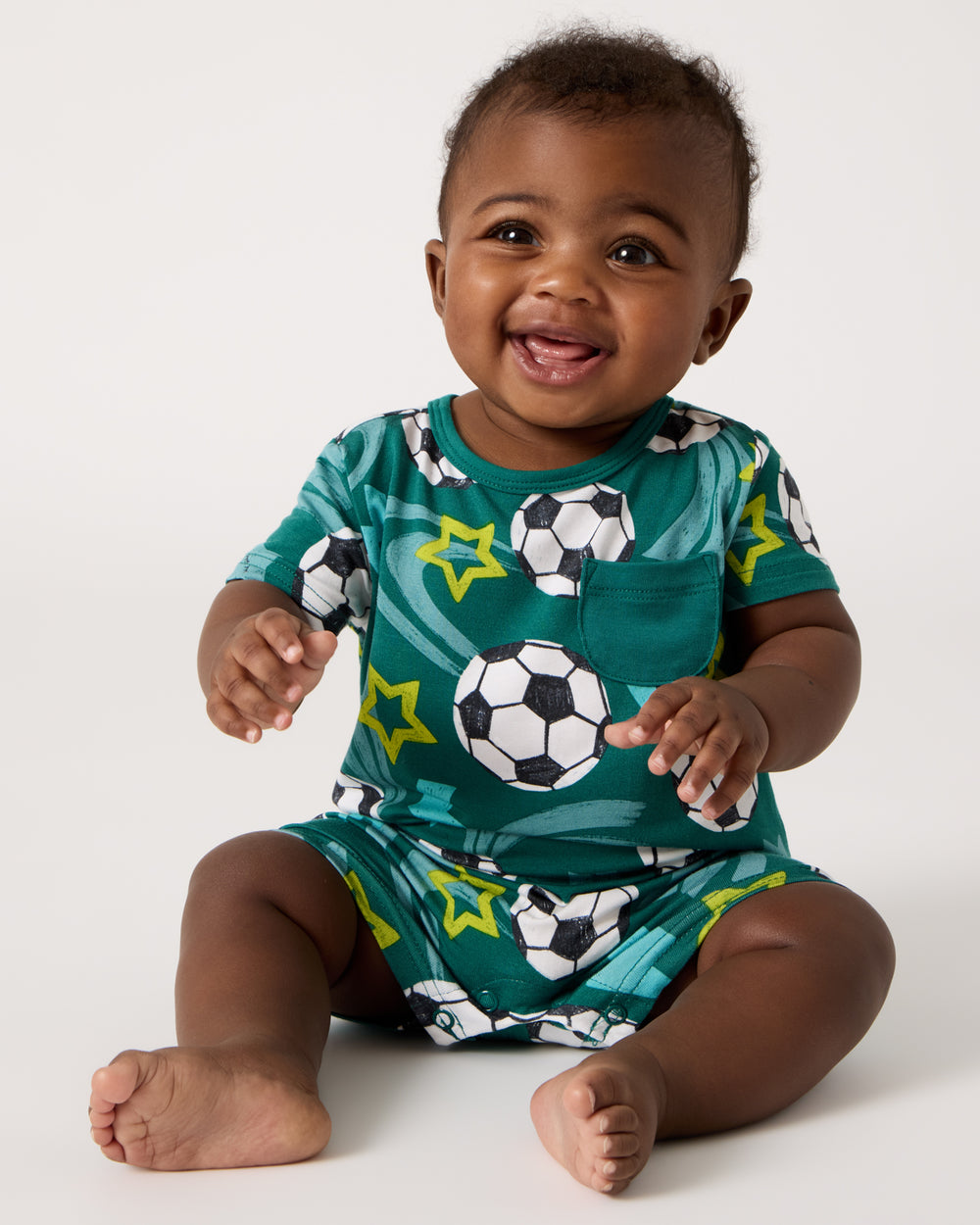 Sitting baby wearing the Soccer Stars Pocket Shorty Romper