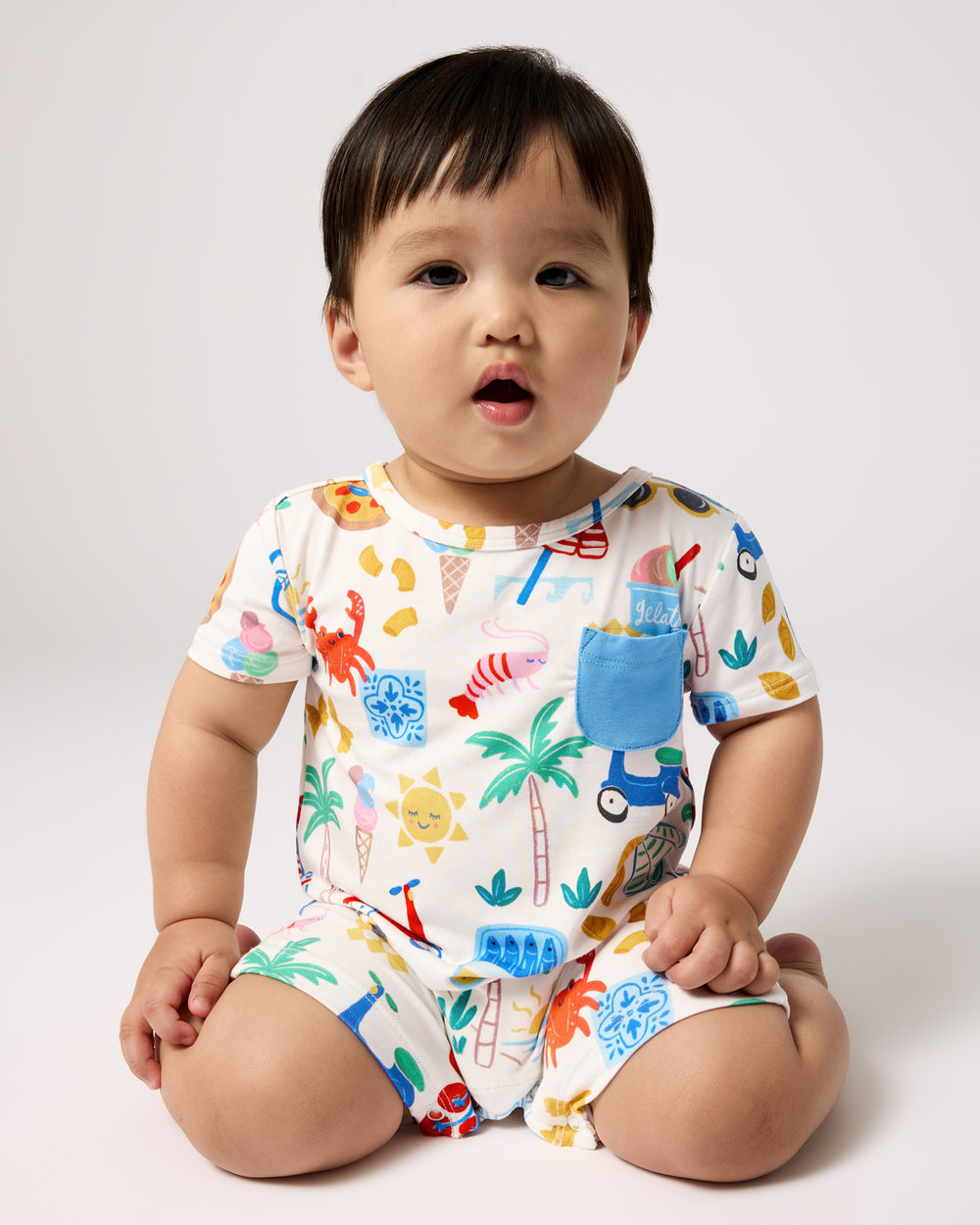 Sitting baby wearing the Ciao Bella Pocket Shorty Romper