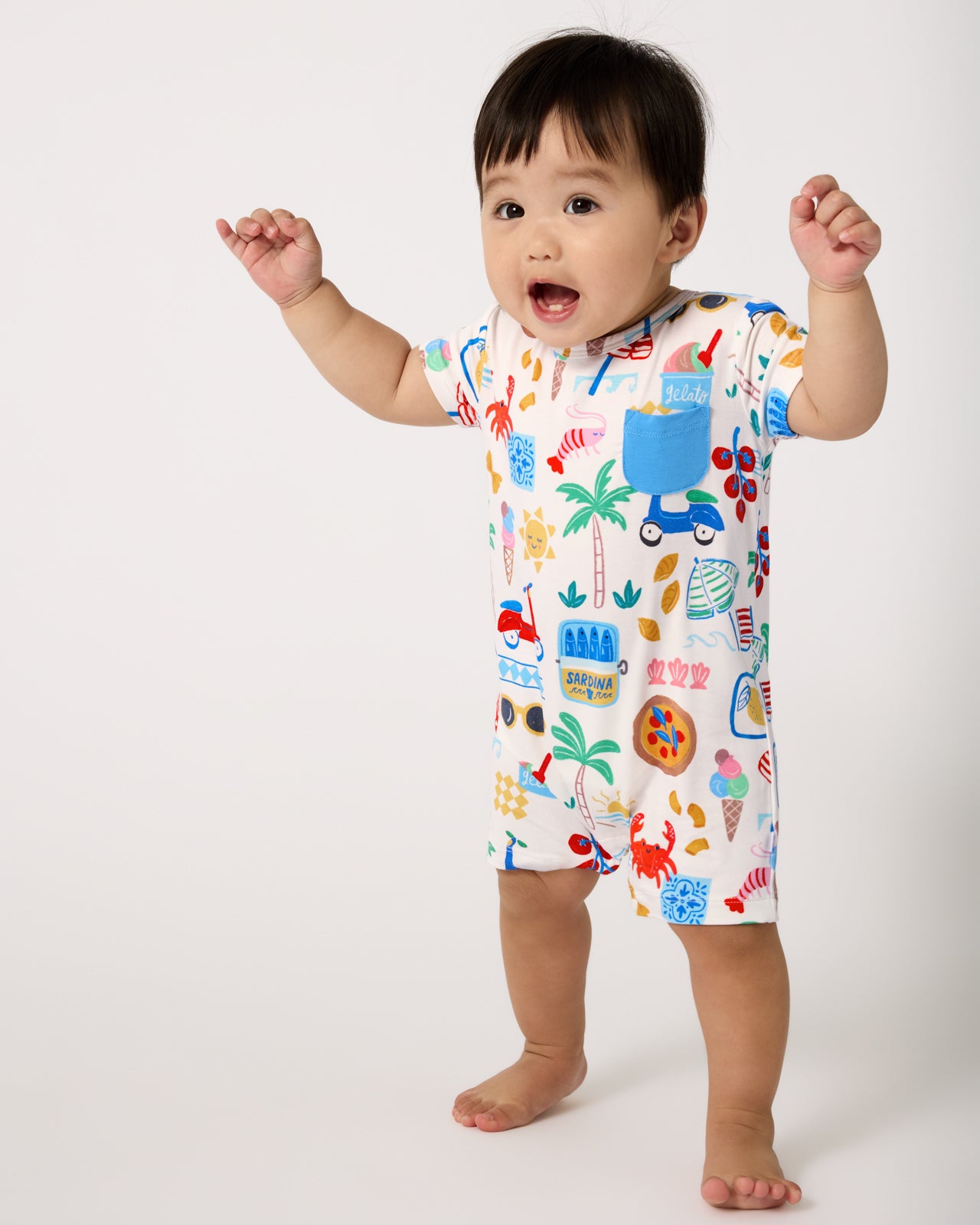 Standing baby wearing the Ciao Bella Pocket Shorty Romper