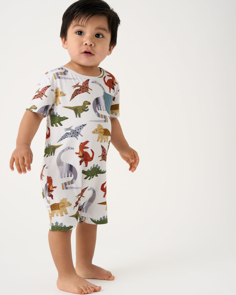 Standing toddler wearing the Roar & Explore Pocket Shorty Romper