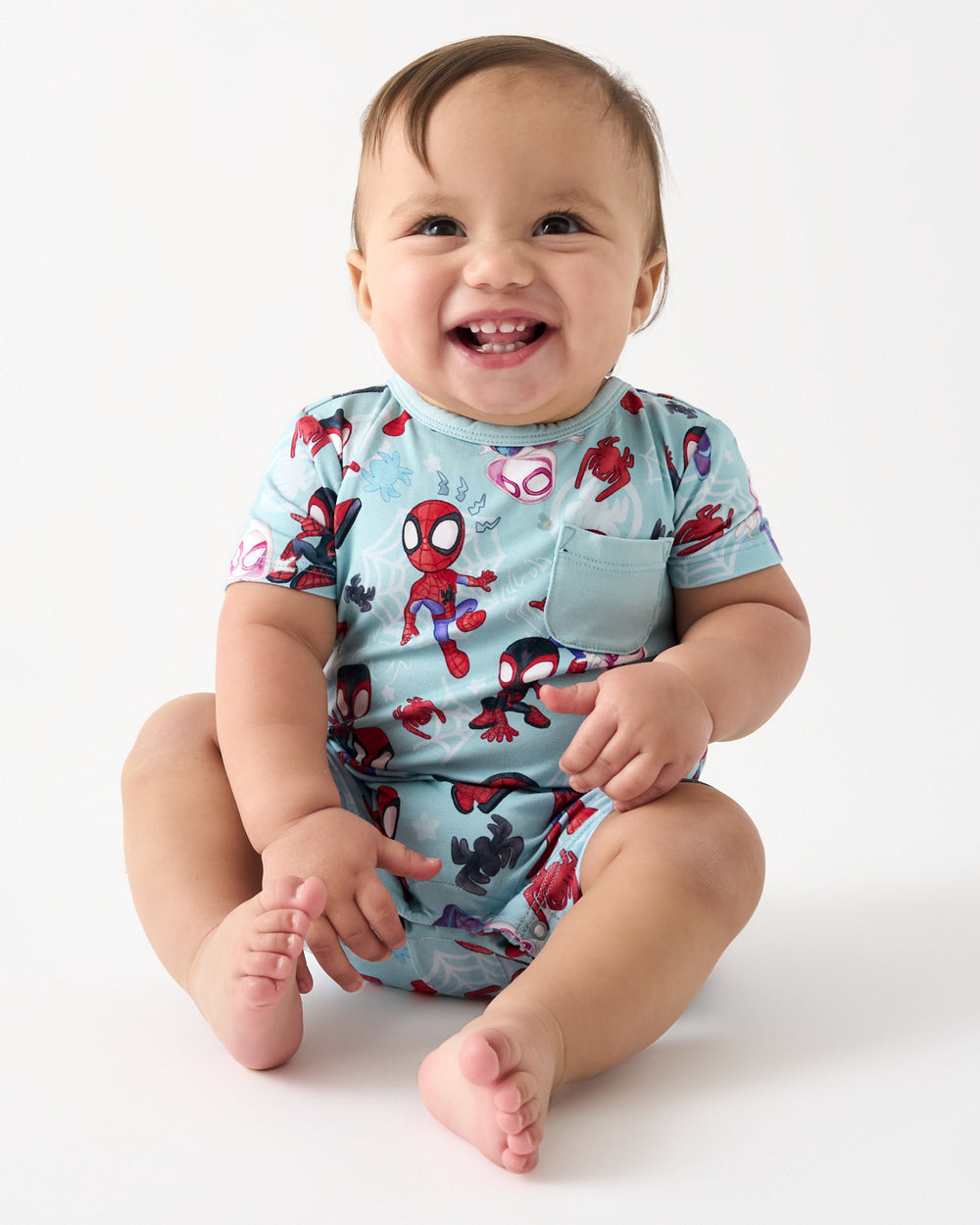 Sitting baby wearing the Spidey & Friends Tiny Webs Pocket Shorty Romper