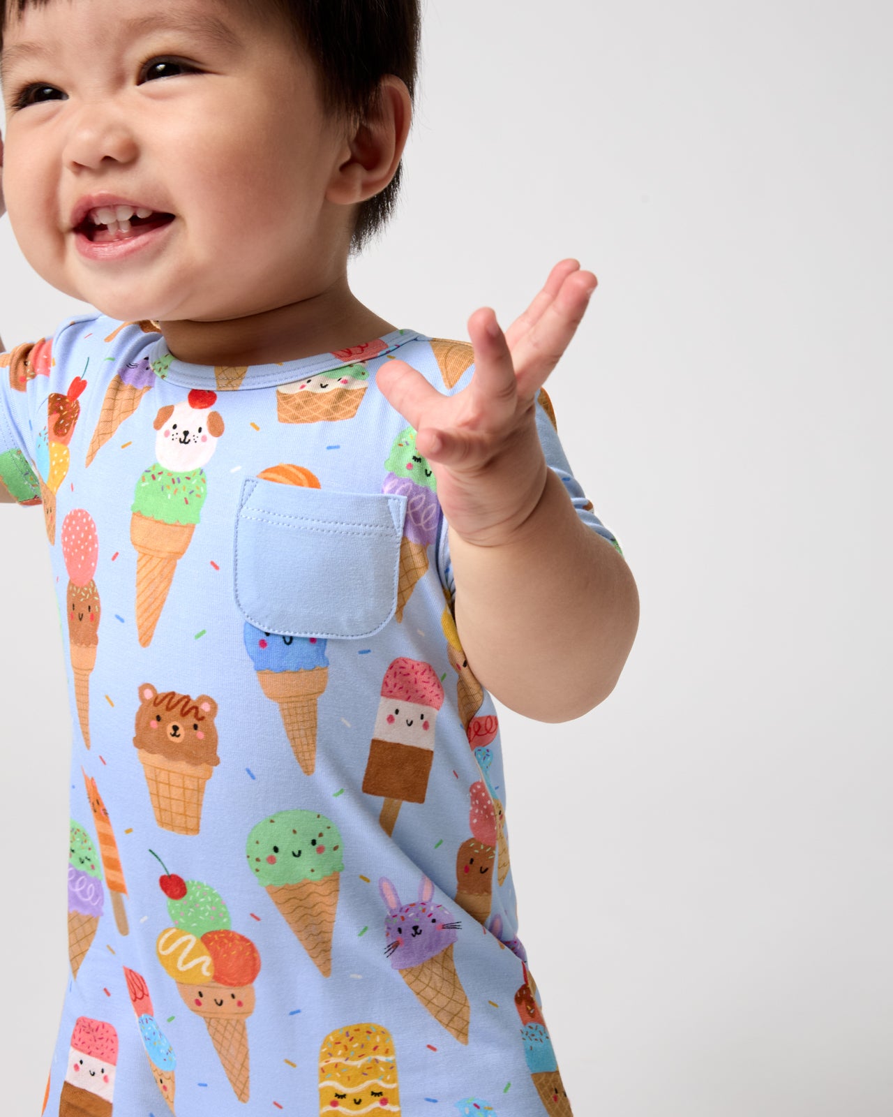 Close up of baby wearing the Scoop Squad Pocket Shorty Romper