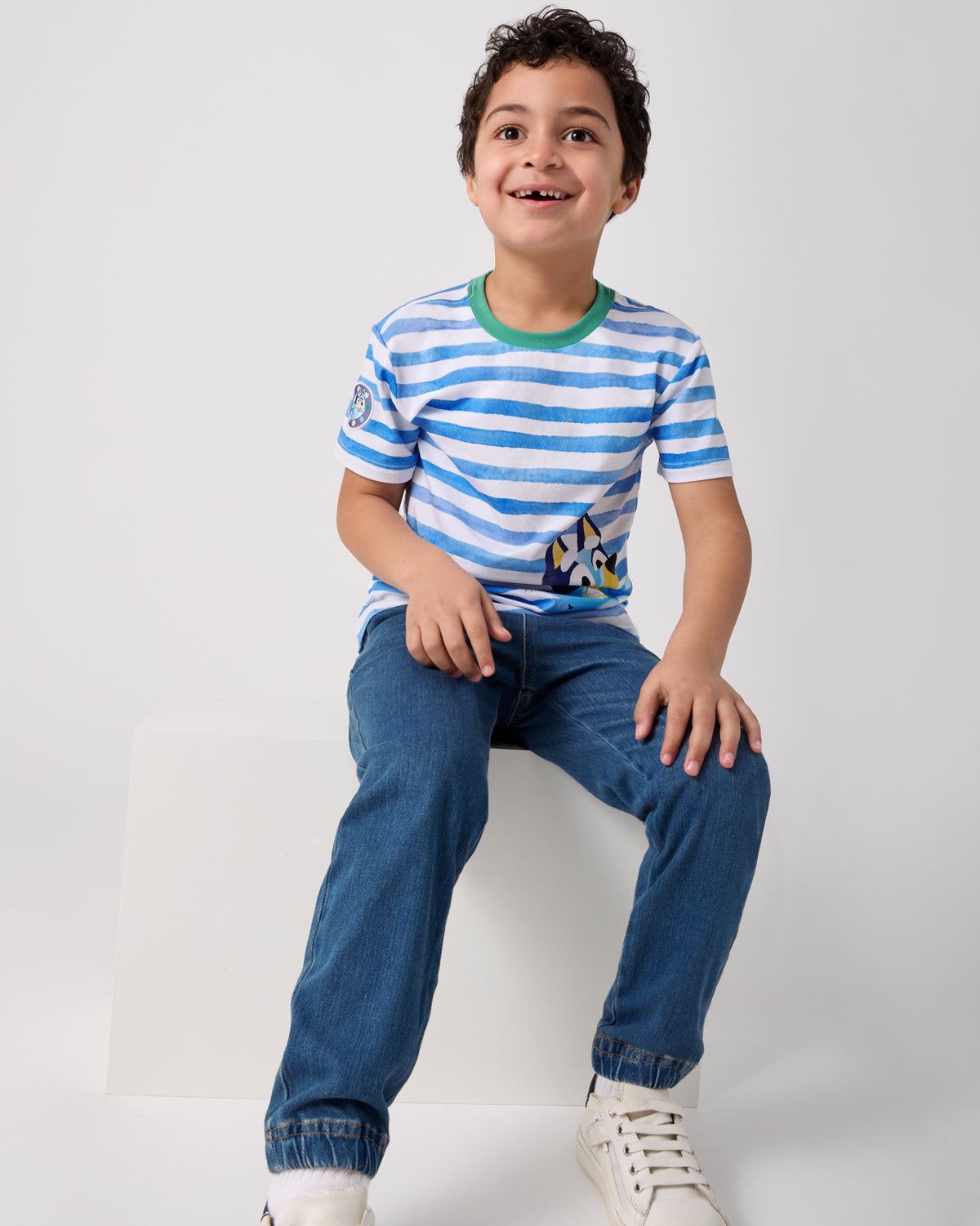 Boy wearing the Bluey Relaxed Tee with denim joggers
