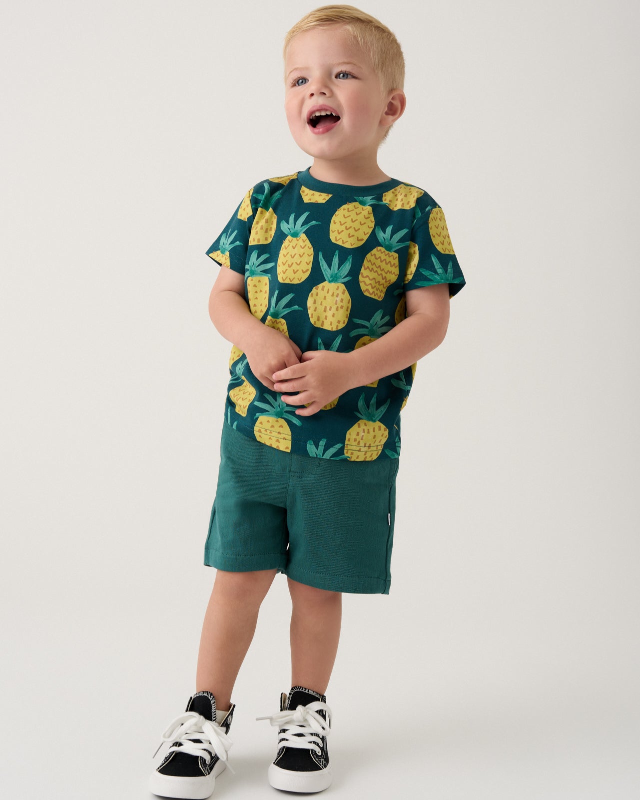 Boy wearing the Pineapple Grove Relaxed Tee with Muted Spruce Chino Shorts