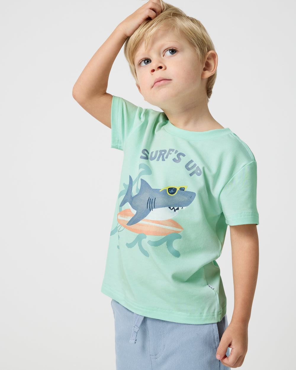 Boy wearing the Surf's Up Relaxed Tee with blue shorts