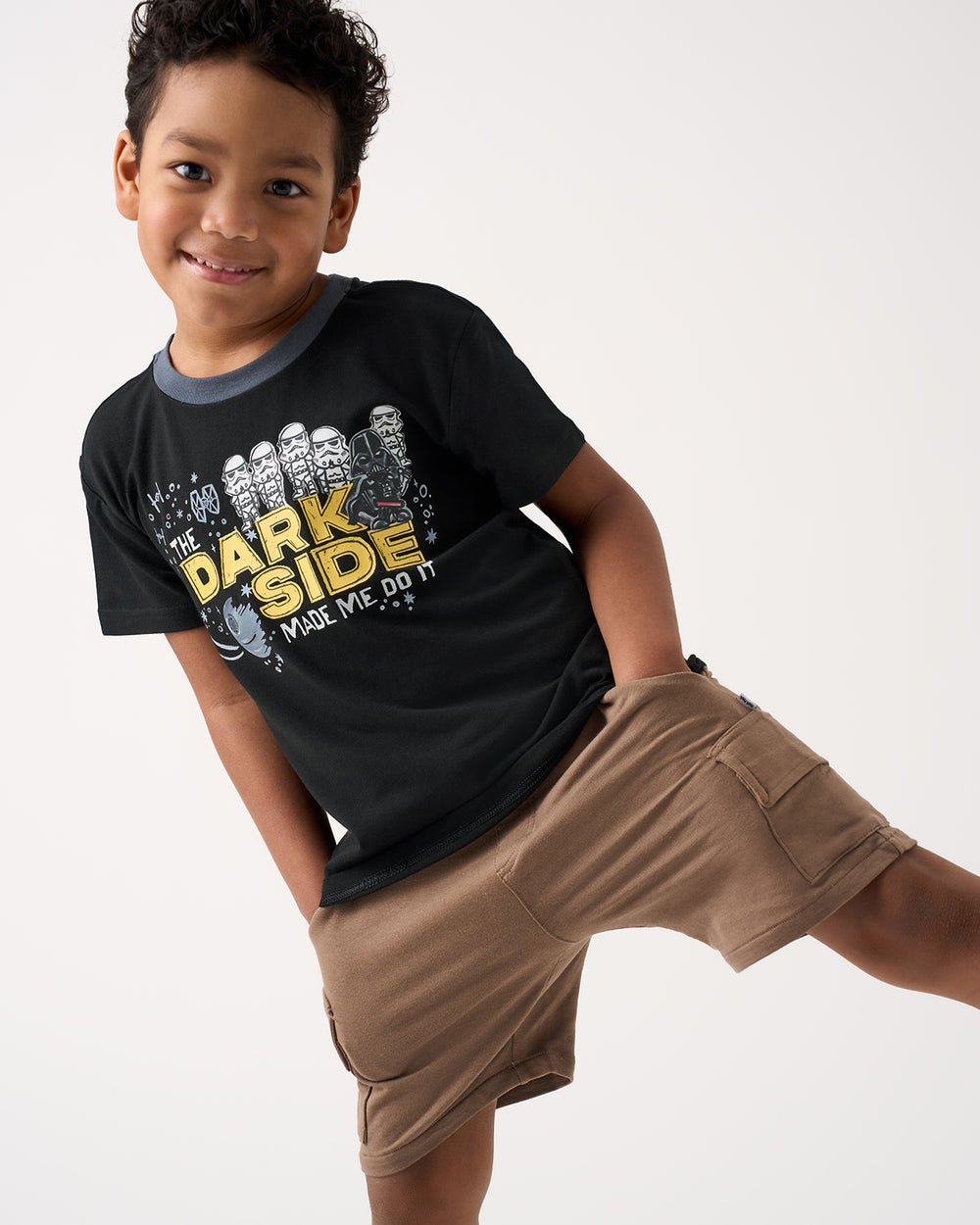Boy wearing the Star Wars Dark Side Relaxed Tee with brown cargo shorts