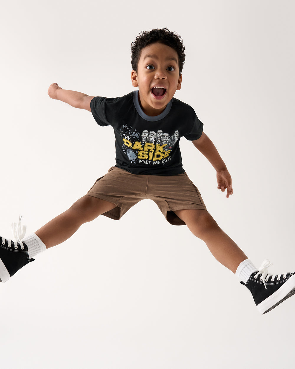 Jumping boy wearing the Star Wars Dark Side Relaxed Tee with brown shorts