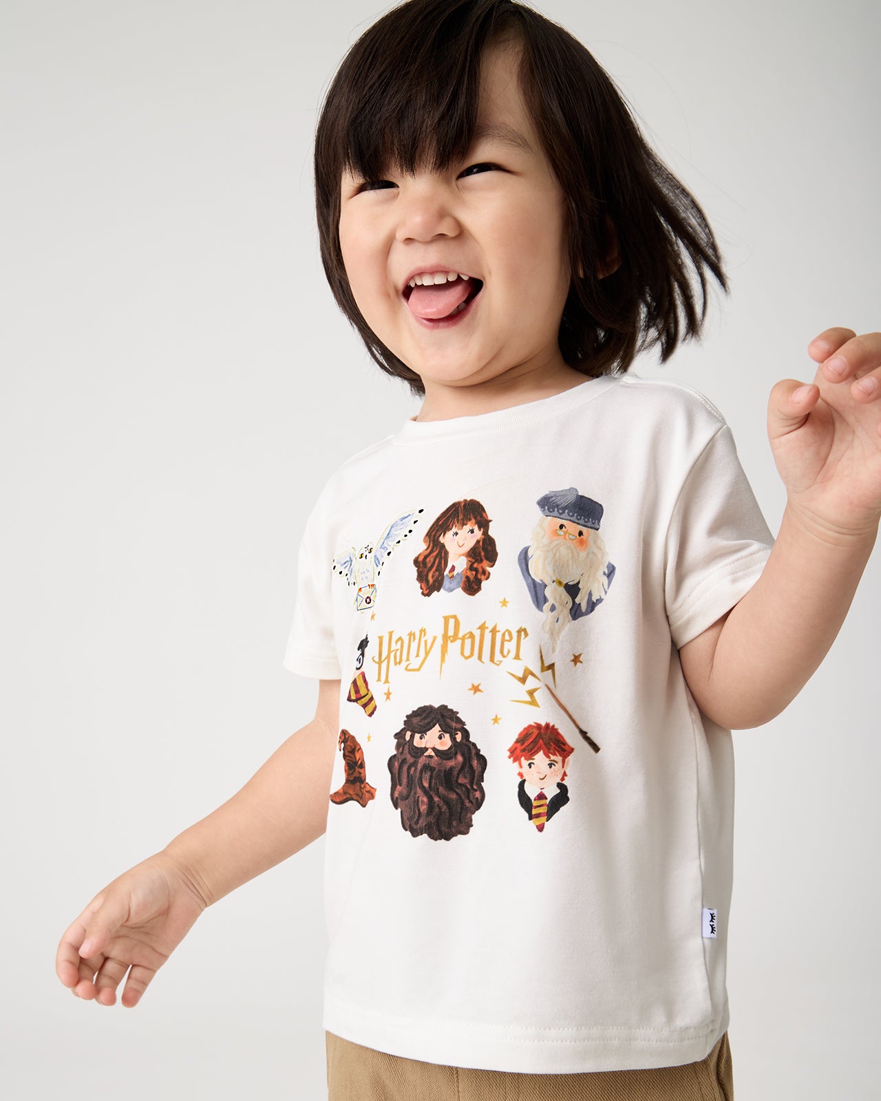 Smiling child wearing the Harry Potter™ Spellbinding Studies Relaxed Tee