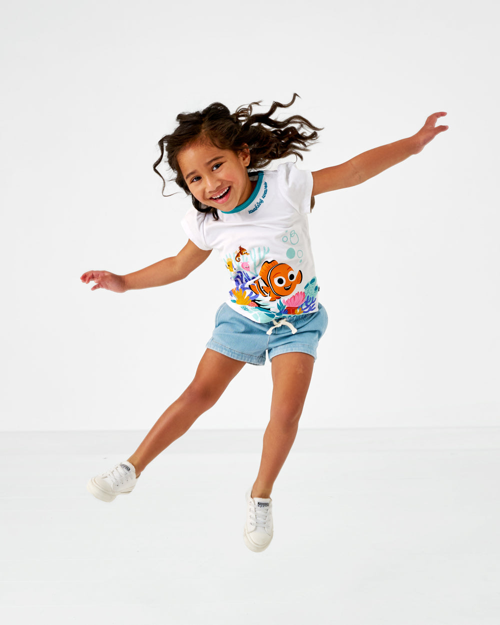 Jumping child wearing the Disney Nemo Puff Sleeve Tee