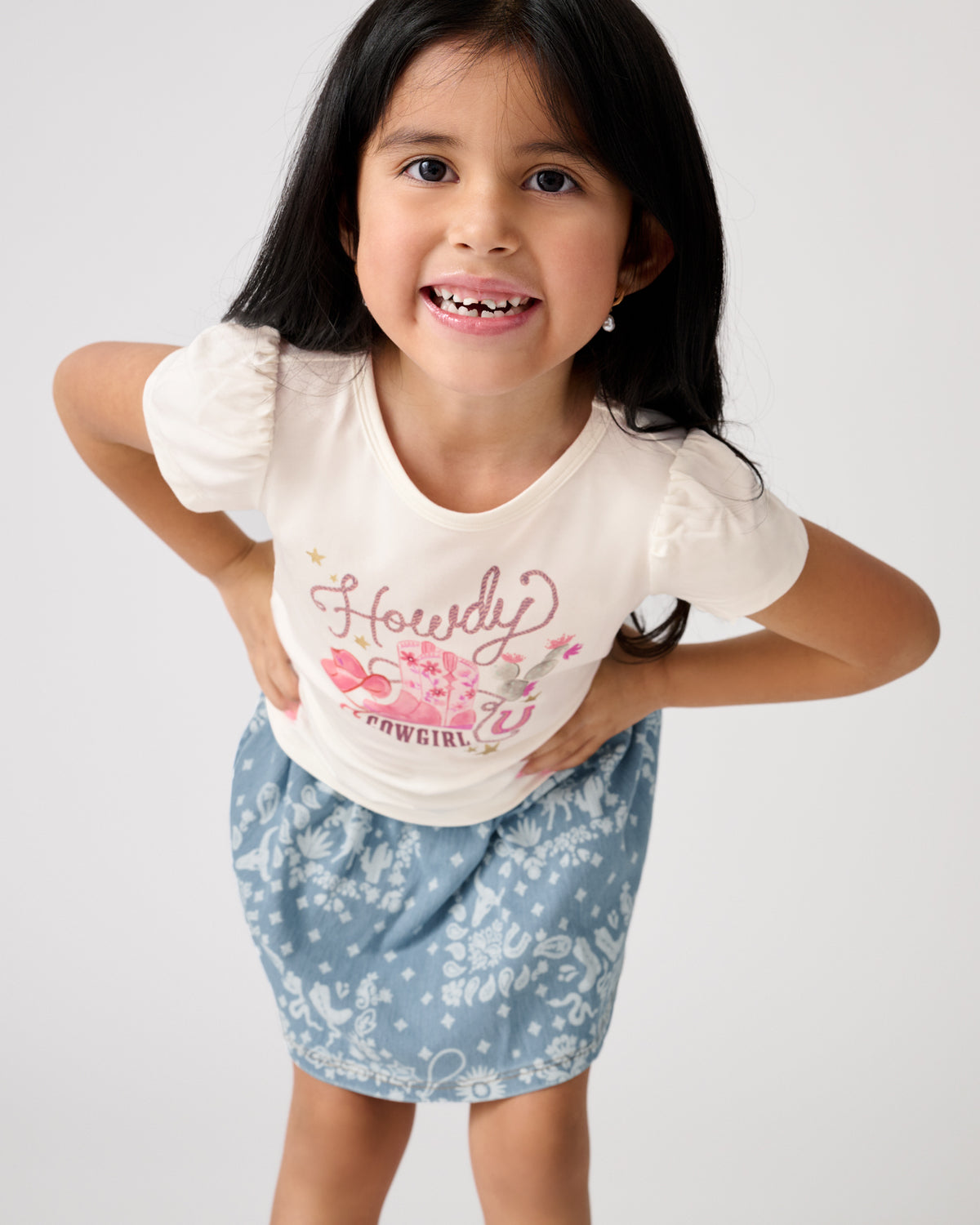 Close up of girl wearing the Howdy Cowgirl Puff Sleeve Tee