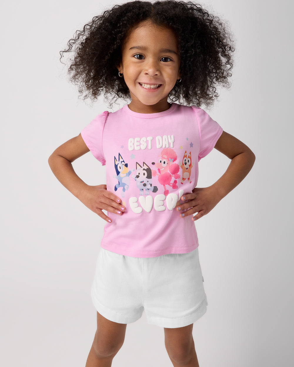 Girl wearing the Bluey Best Day Ever Puff Sleeve Tee with white denim shorts