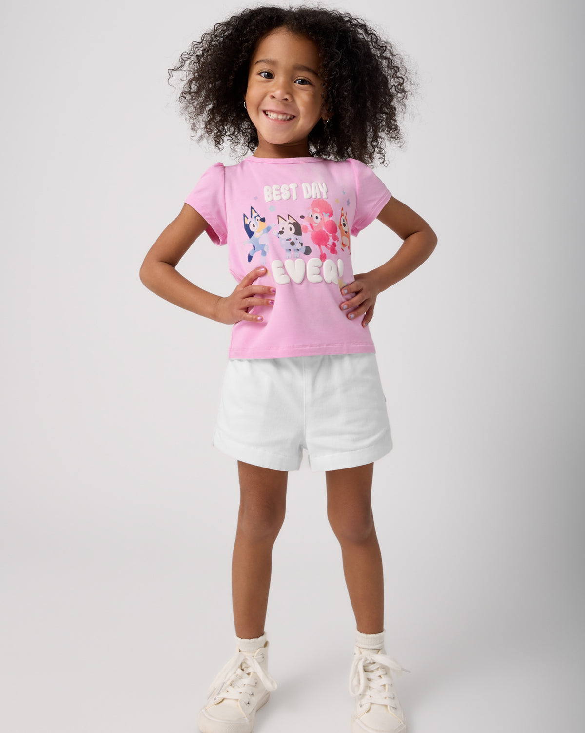 Standing child wearing the Bluey Best Day Ever Puff Sleeve Tee with white shorts