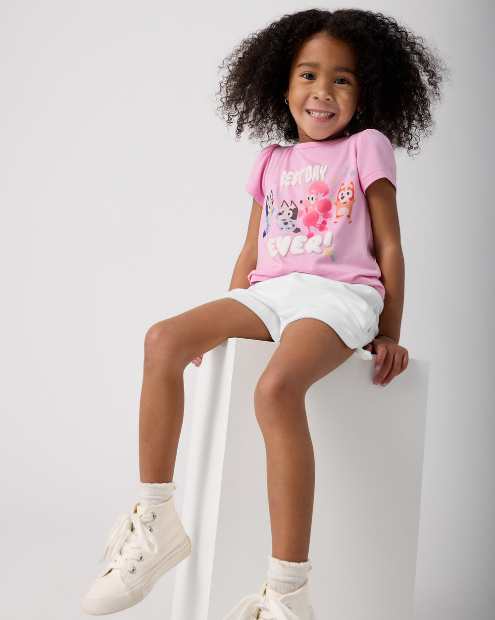 Sitting girl wearing the Bluey Best Day Ever Puff Sleeve Tee