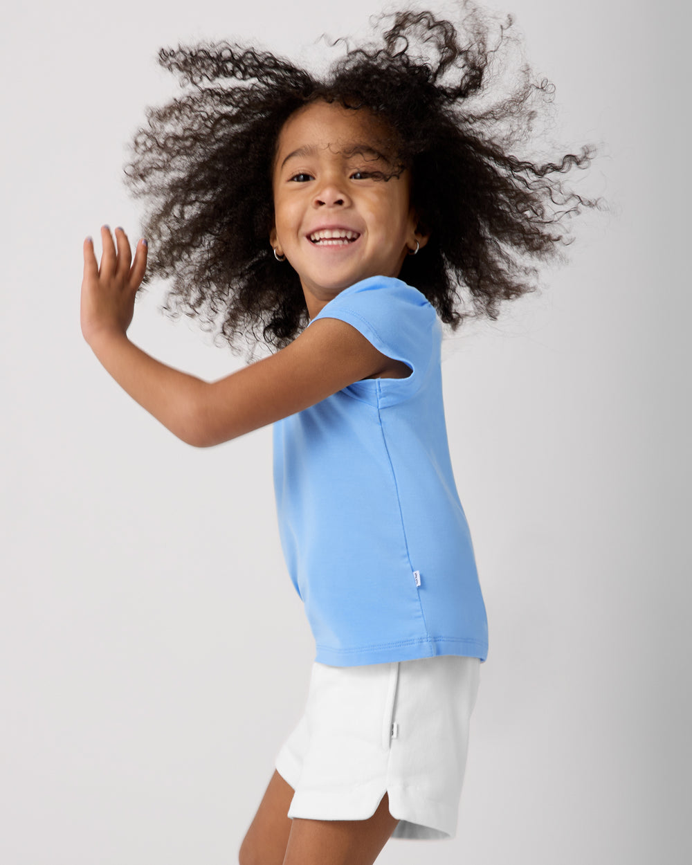 Child in motion wearing the Blue Breeze Puff Sleeve Tee