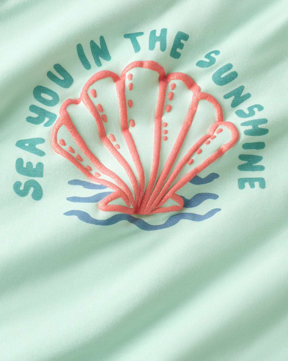 Close up of the graphic on the Sparkling Seas Puff Sleeve Tee