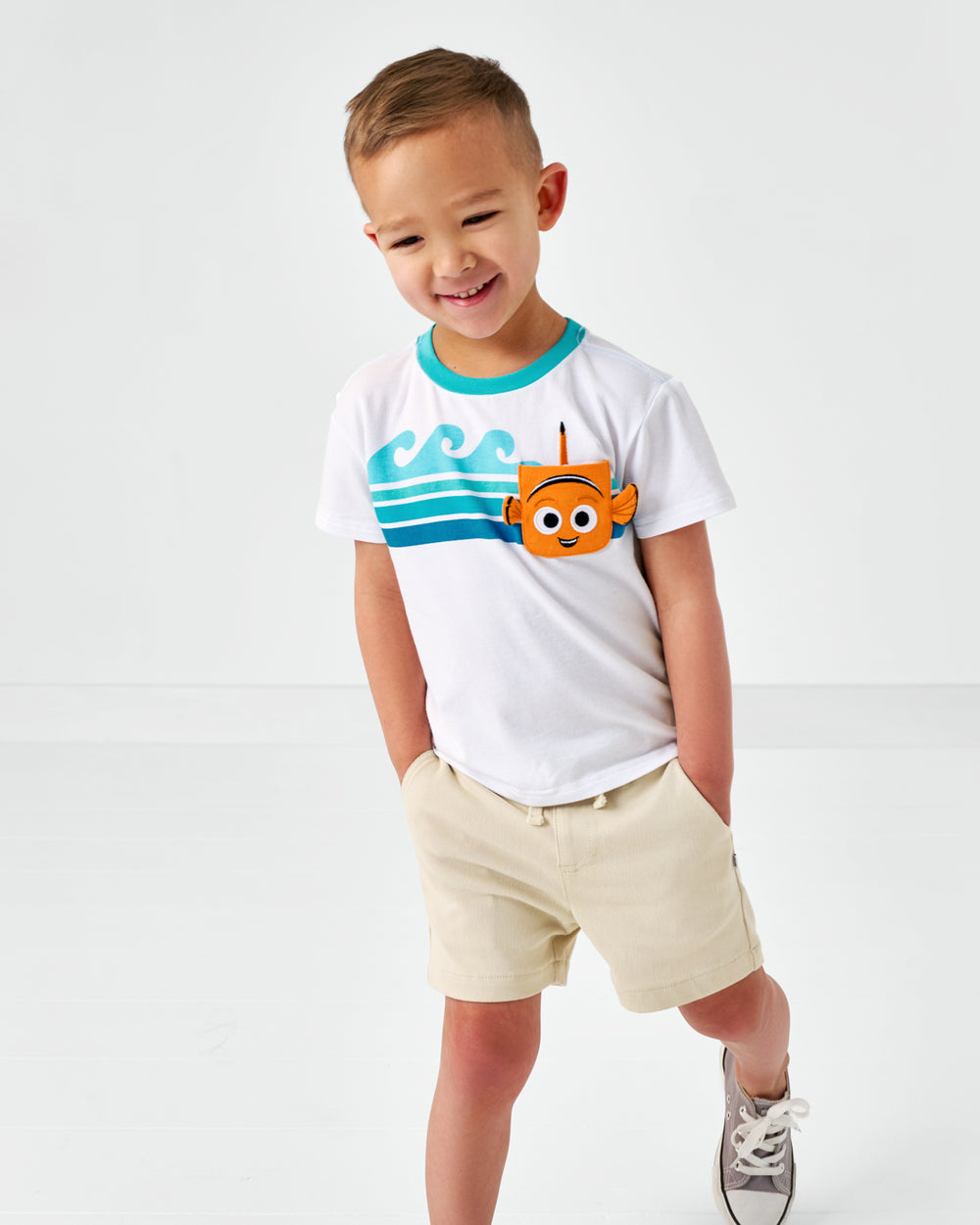 Child wearing the Disney Nemo Relaxed Pocket Tee with Light Khaki Bamboo Chino Shorts