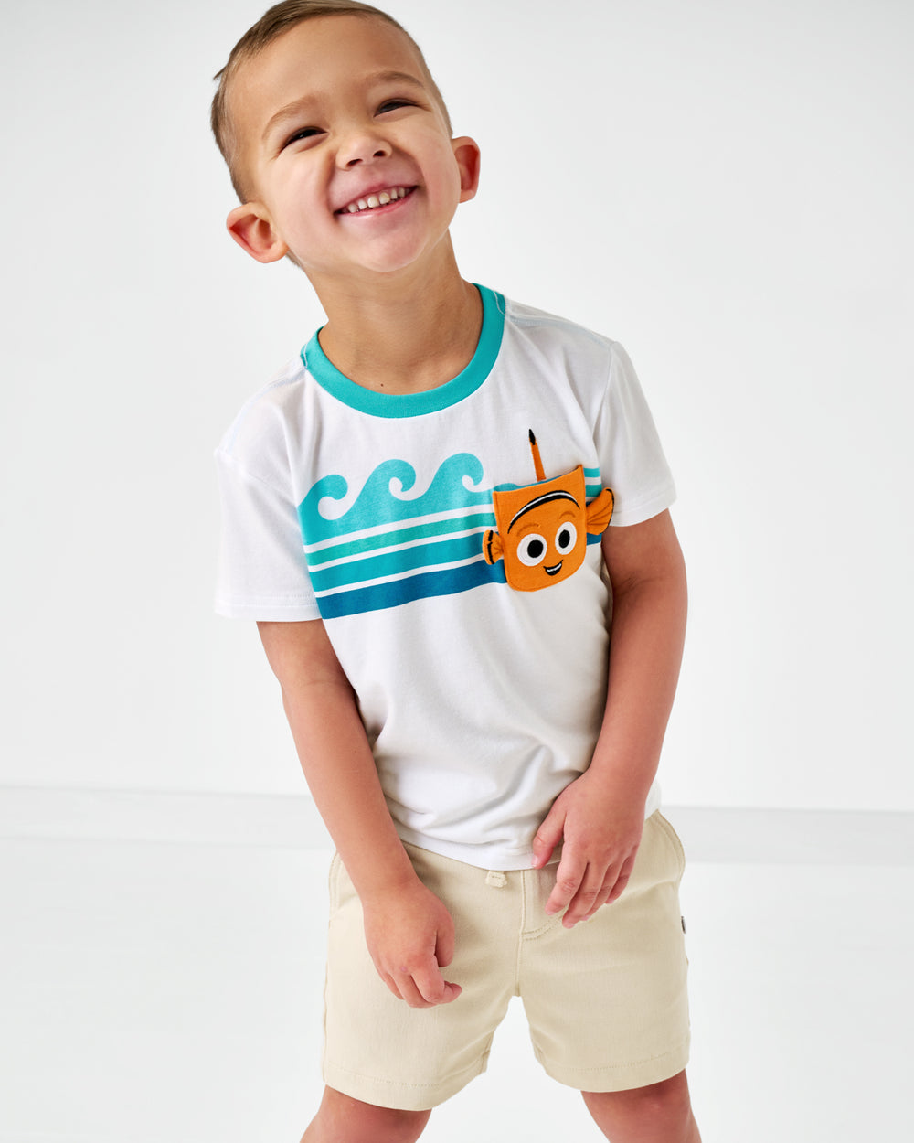 Smiling child wearing the Disney Nemo Relaxed Pocket Tee