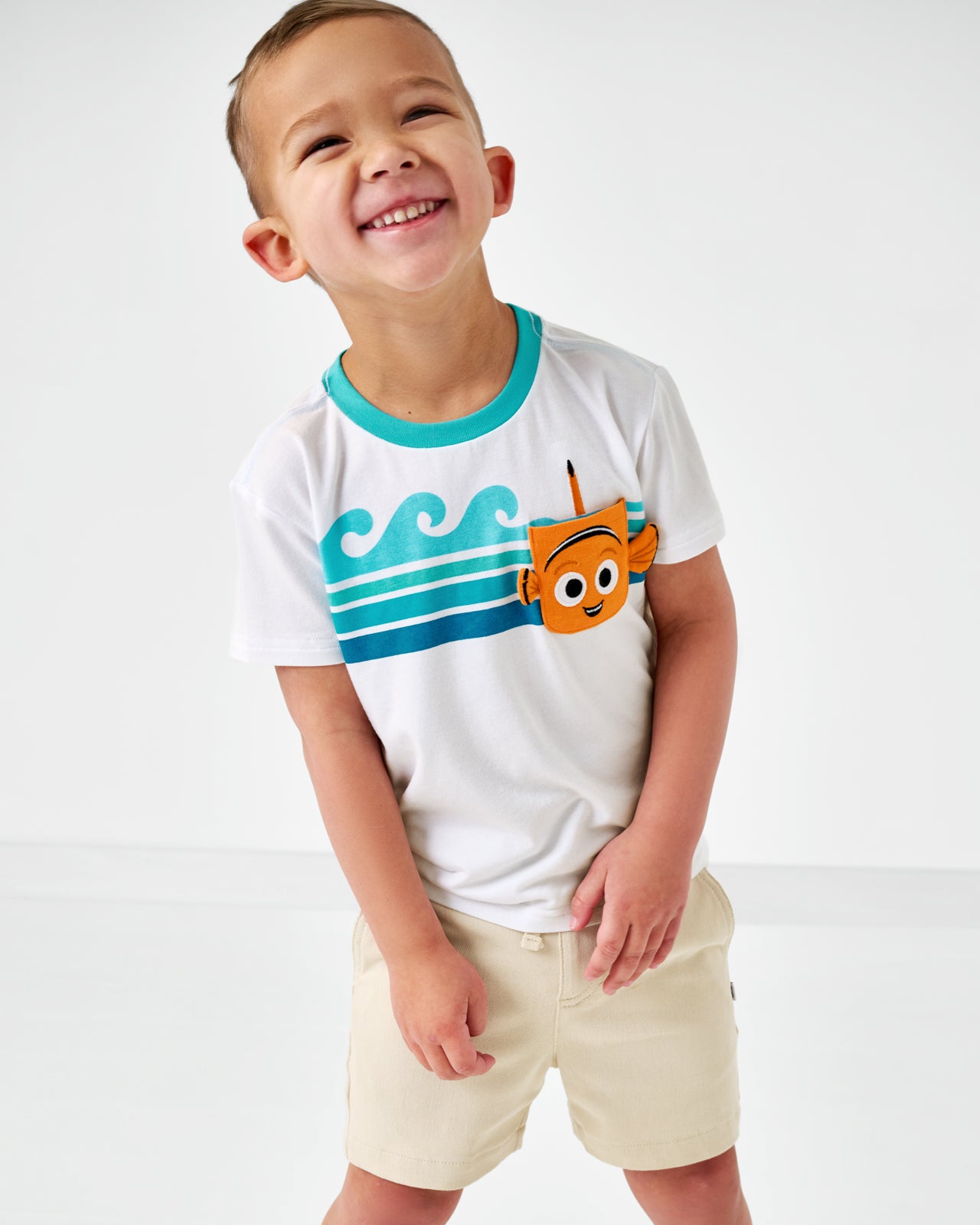 Smiling child wearing the Disney Nemo Relaxed Pocket Tee