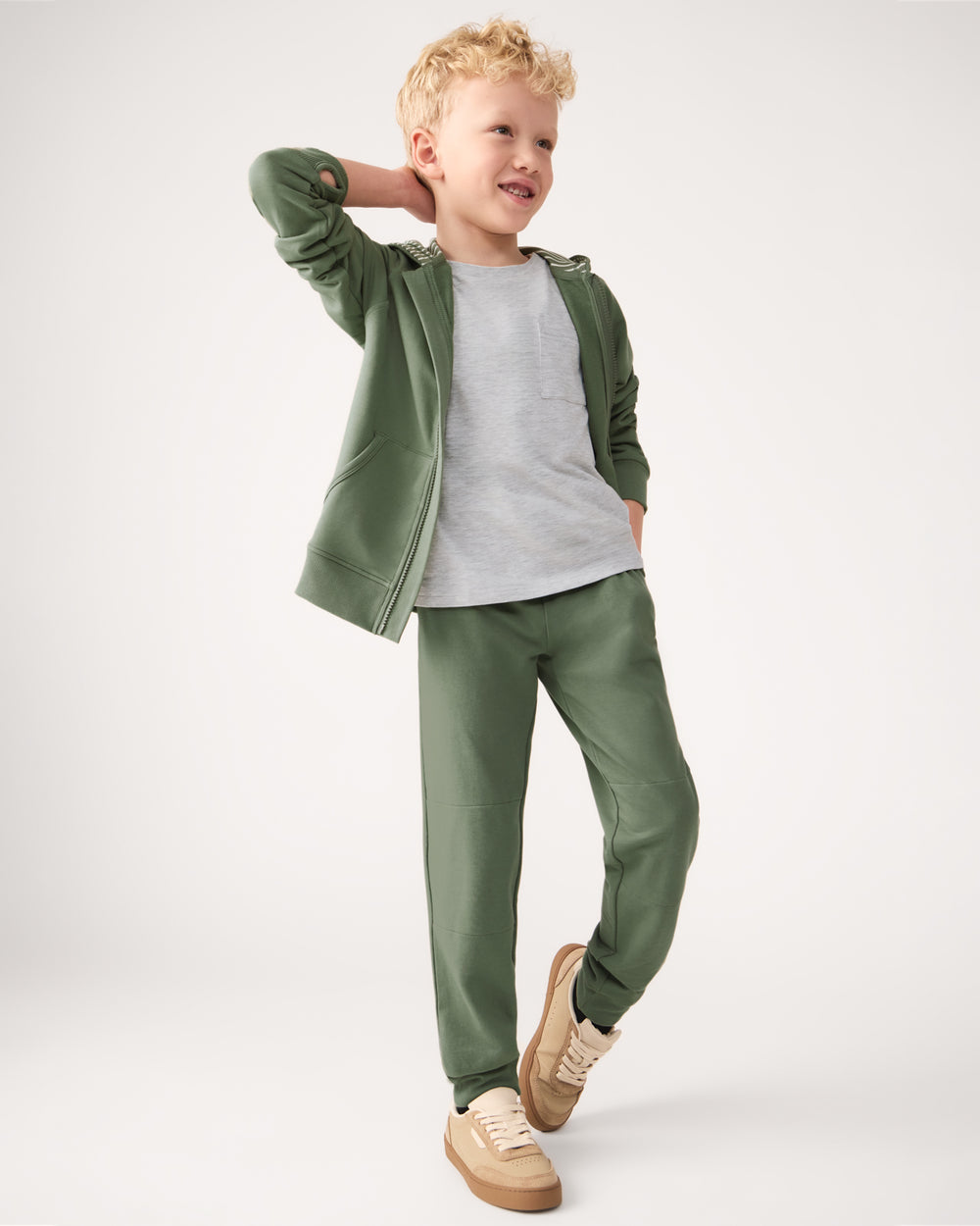 Boy wearing the Moss Zip Hoodie and Jogger Sweatpants