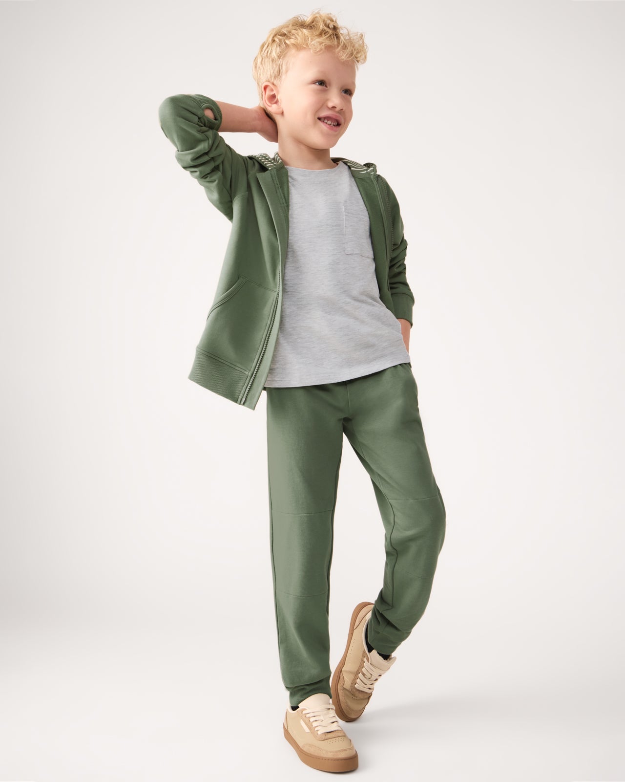 Boy wearing the Moss Zip Hoodie and Jogger Sweatpants