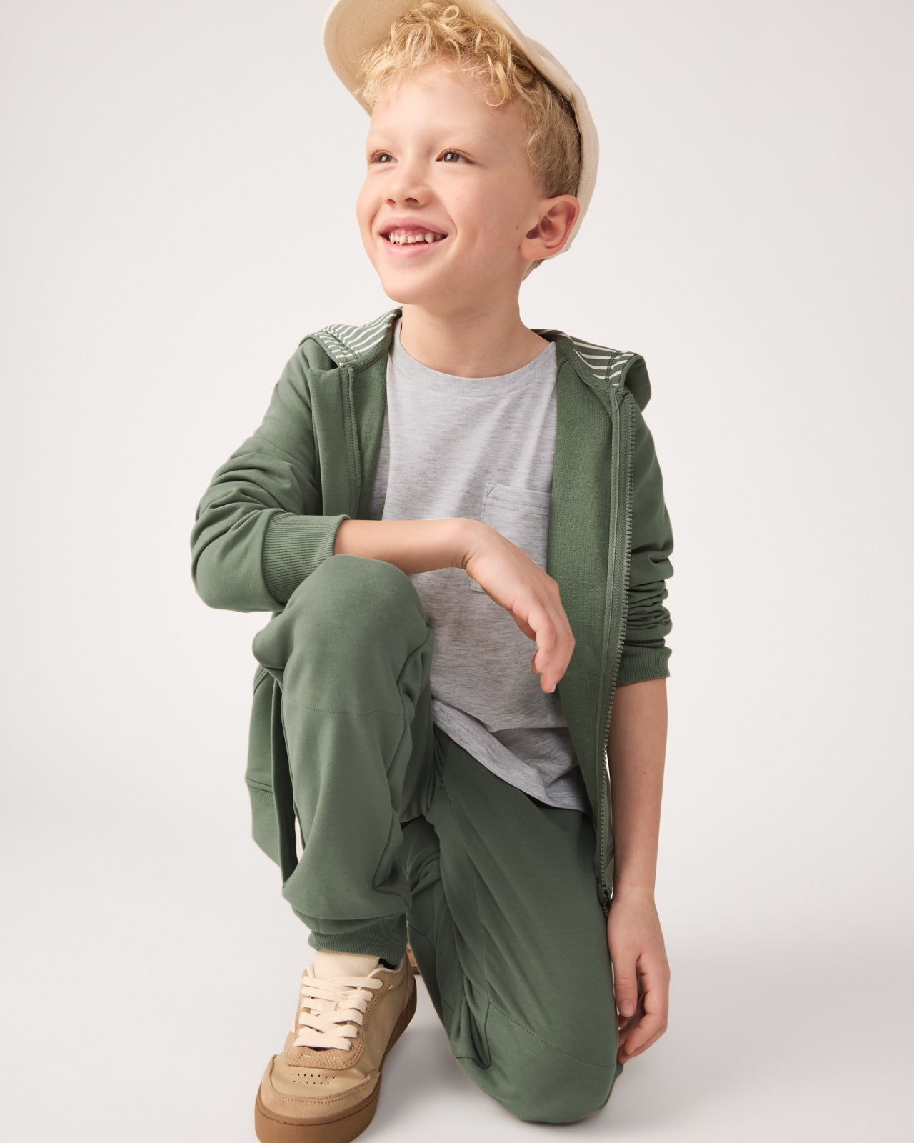Kneeling child wearing the Moss Joggers