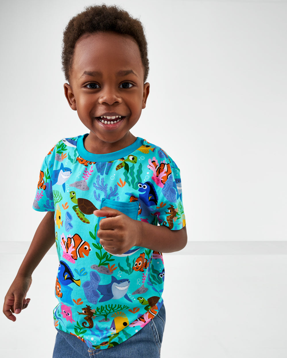 Close up of child wearing the Disney Nemo's Reef Relaxed Pocket Tee