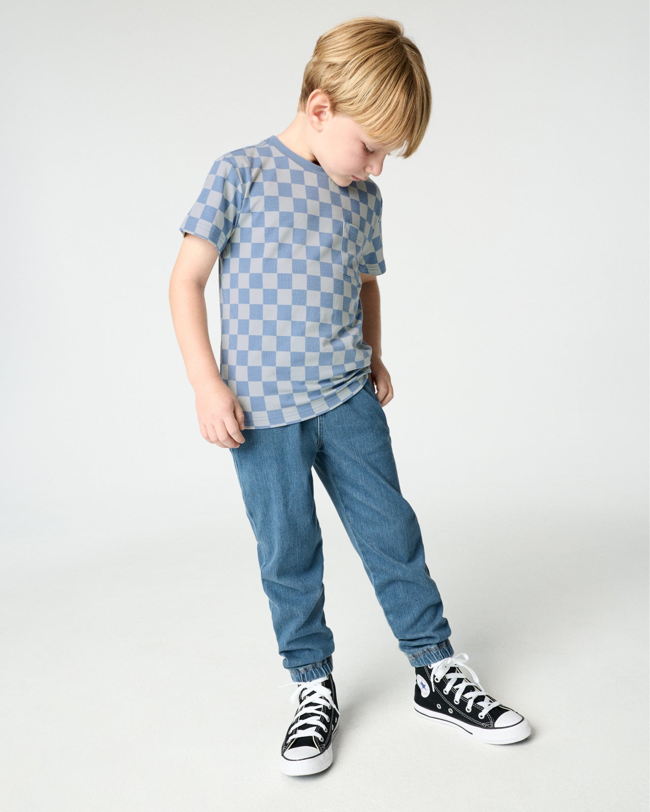 Boy wearing the Dusk Blue Checks Relaxed Pocket Tee with denim joggers