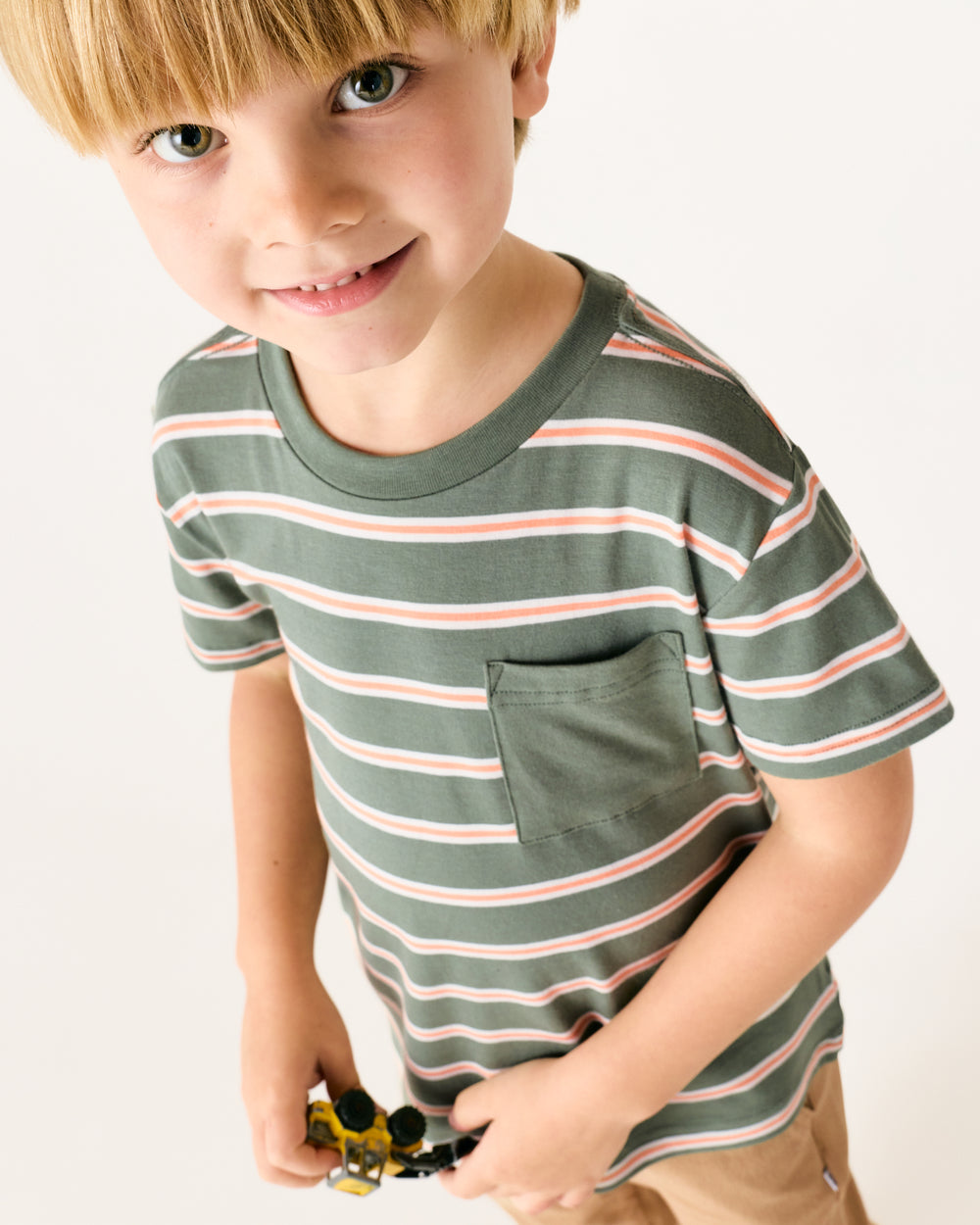 Close up of boy wearing the Moss Stripe Relaxed Pocket Tee