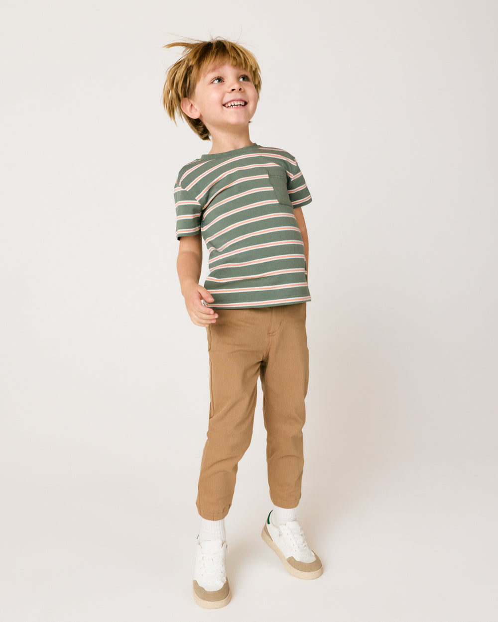 Child in motion wearing the Moss Stripe Relaxed Pocket Tee with denim joggers