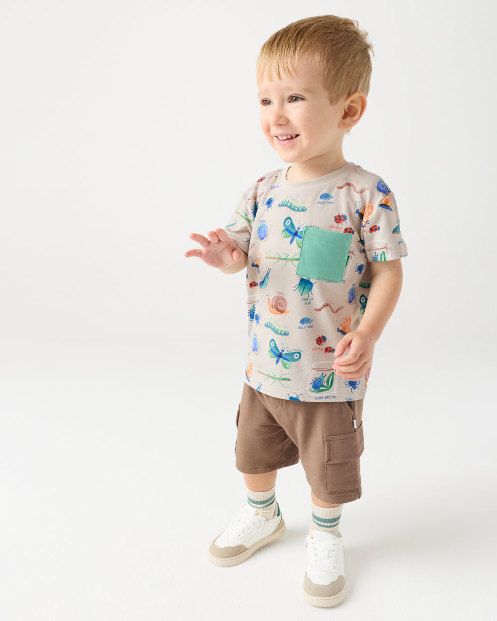 Standing child wearing the Nature Notes Relaxed Pocket Tee