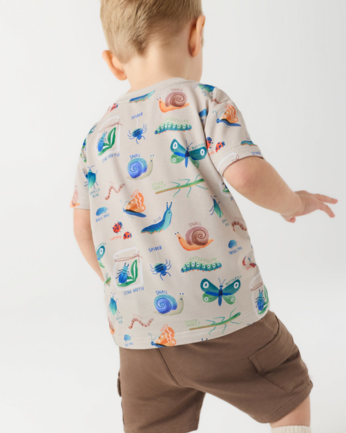 Back view of boy wearing the Nature Notes Insect Print Tee