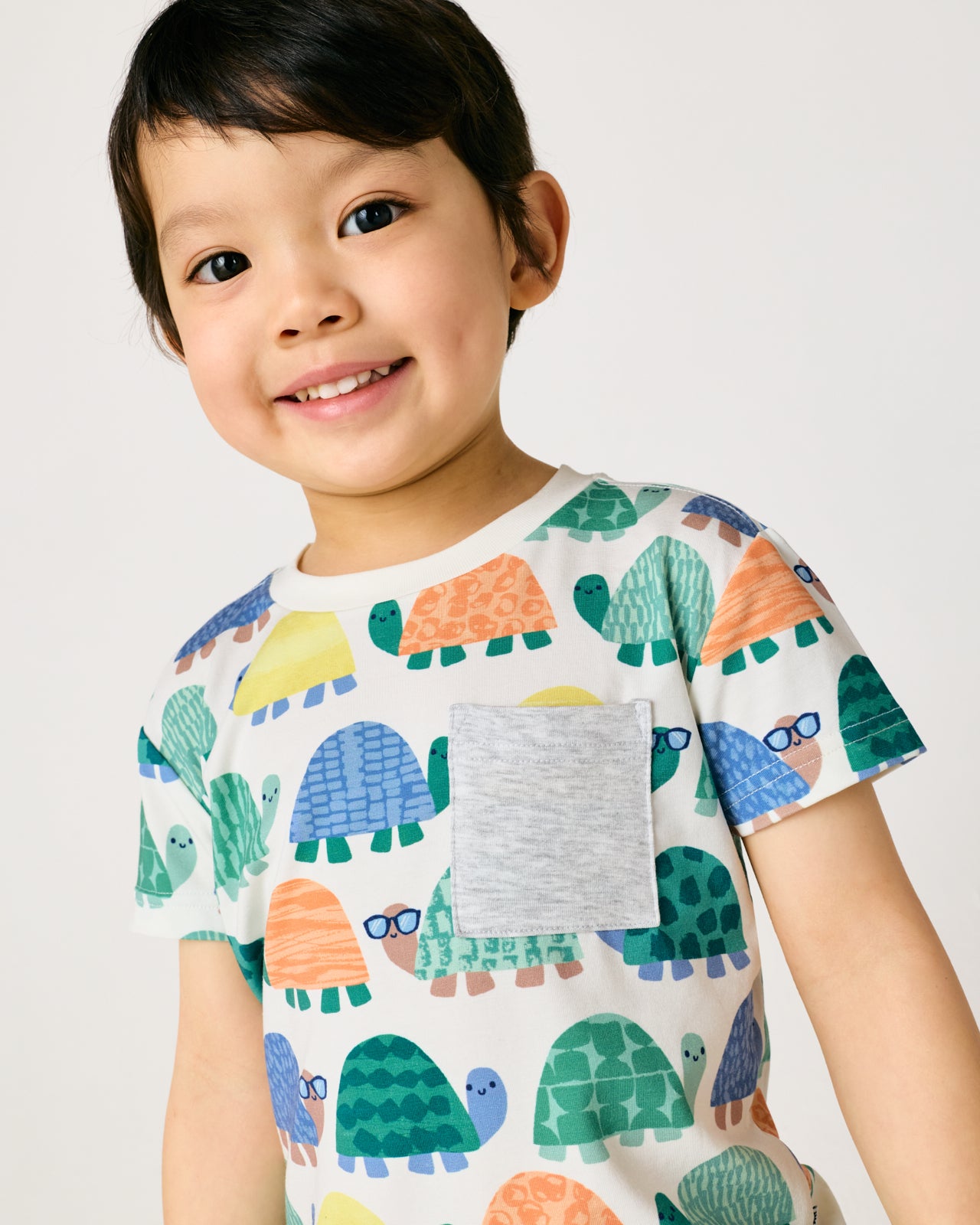 Close up of boy wearing the Shell Parade Relaxed Pocket Tee