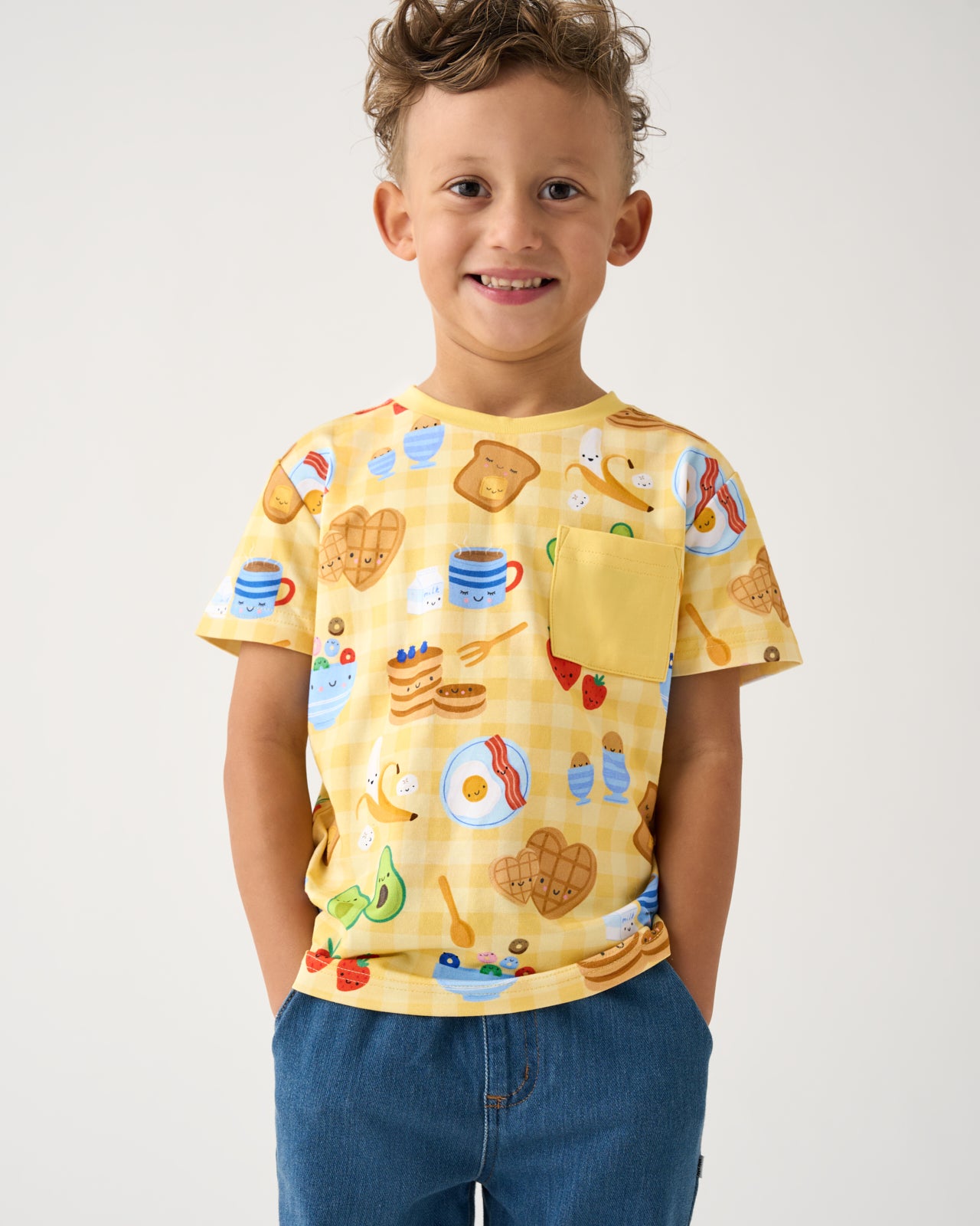Boy wearing the Breakfast Bunch Relaxed Pocket Tee with denim pants