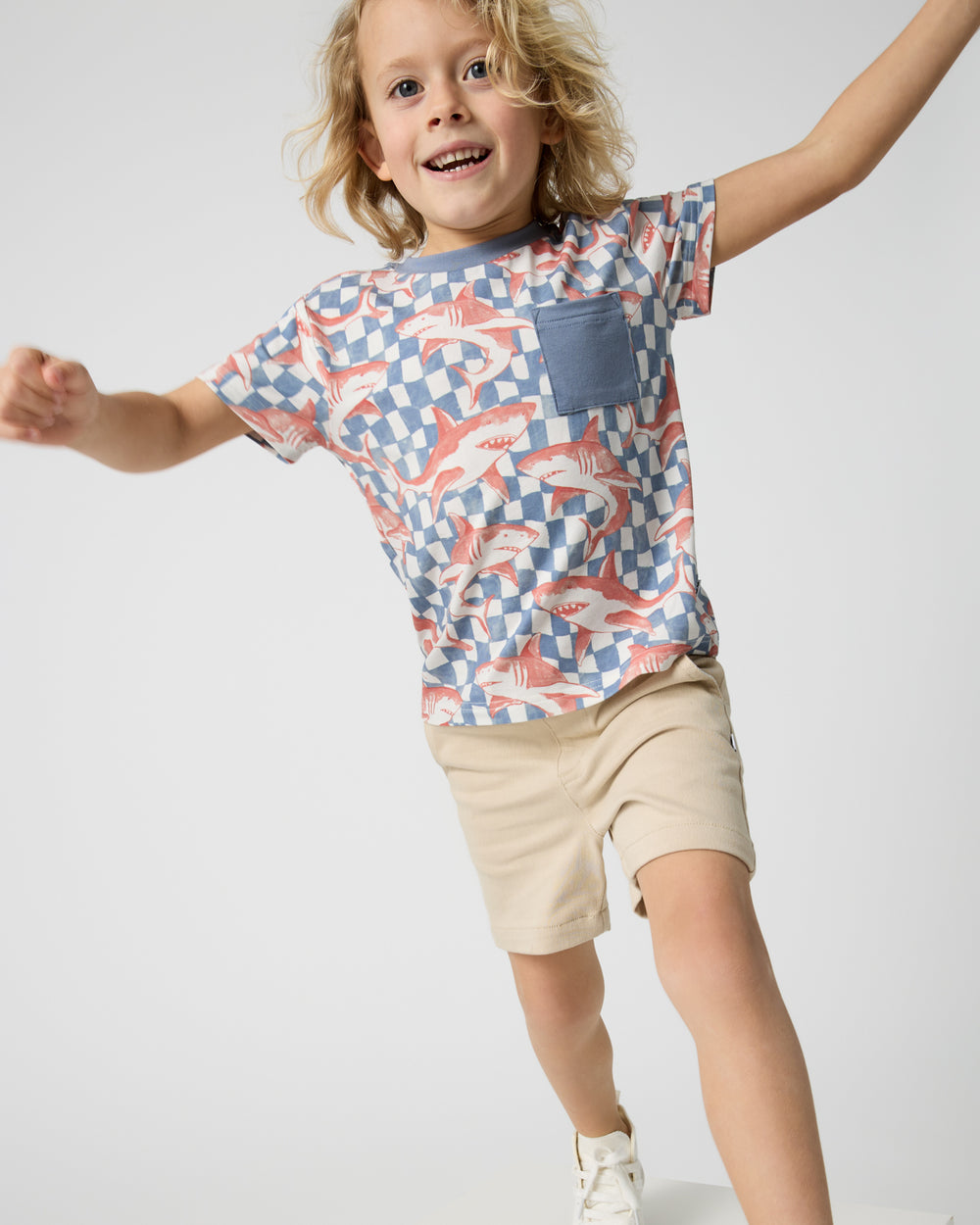 Child in motion wearing the Shark Fin Checks Relaxed Pocket Tee