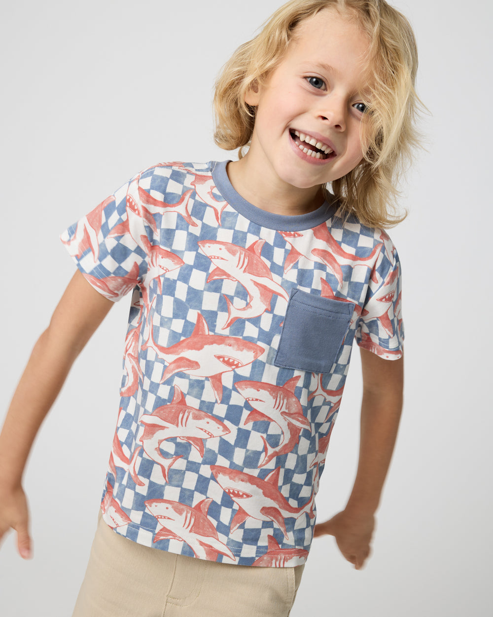 Close up of boy wearing the Shark Fin Checks Relaxed Pocket Tee