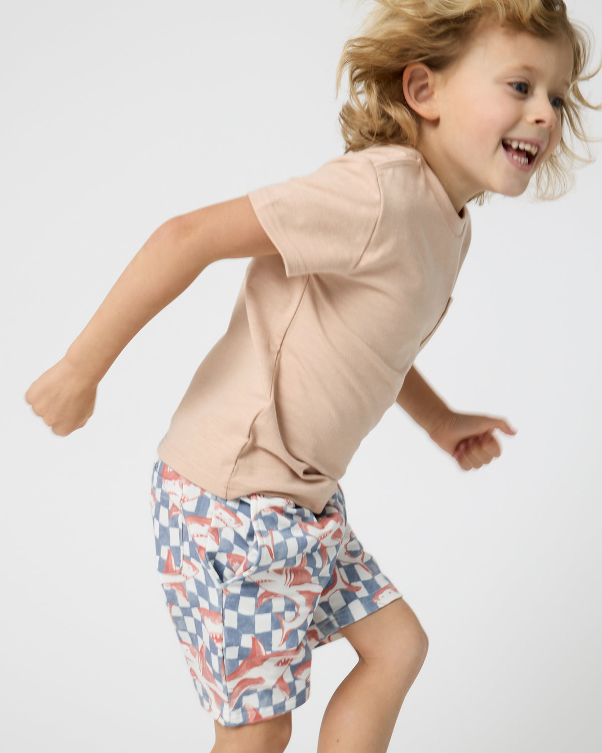 Child in motion wearing the Sand Bar Relaxed Pocket Tee