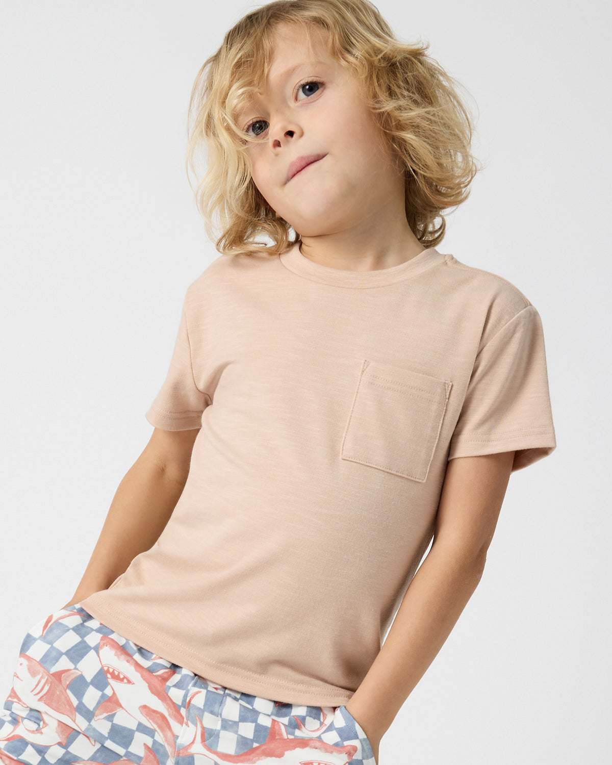 Close up of boy wearing the Sand Bar Relaxed Pocket Tee