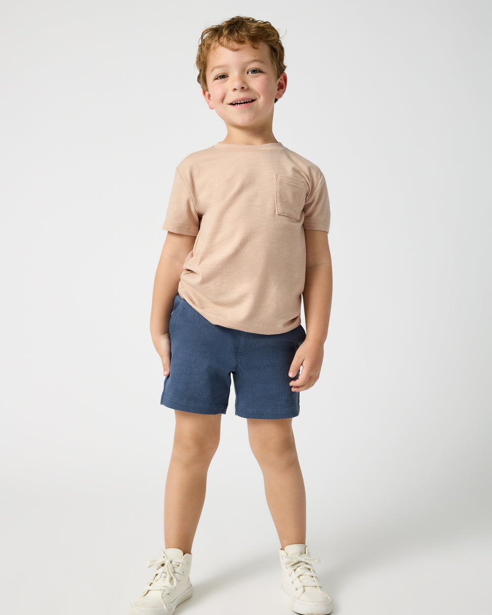 Boy wearing the Vintage Navy Chino Shorts with a tan tee
