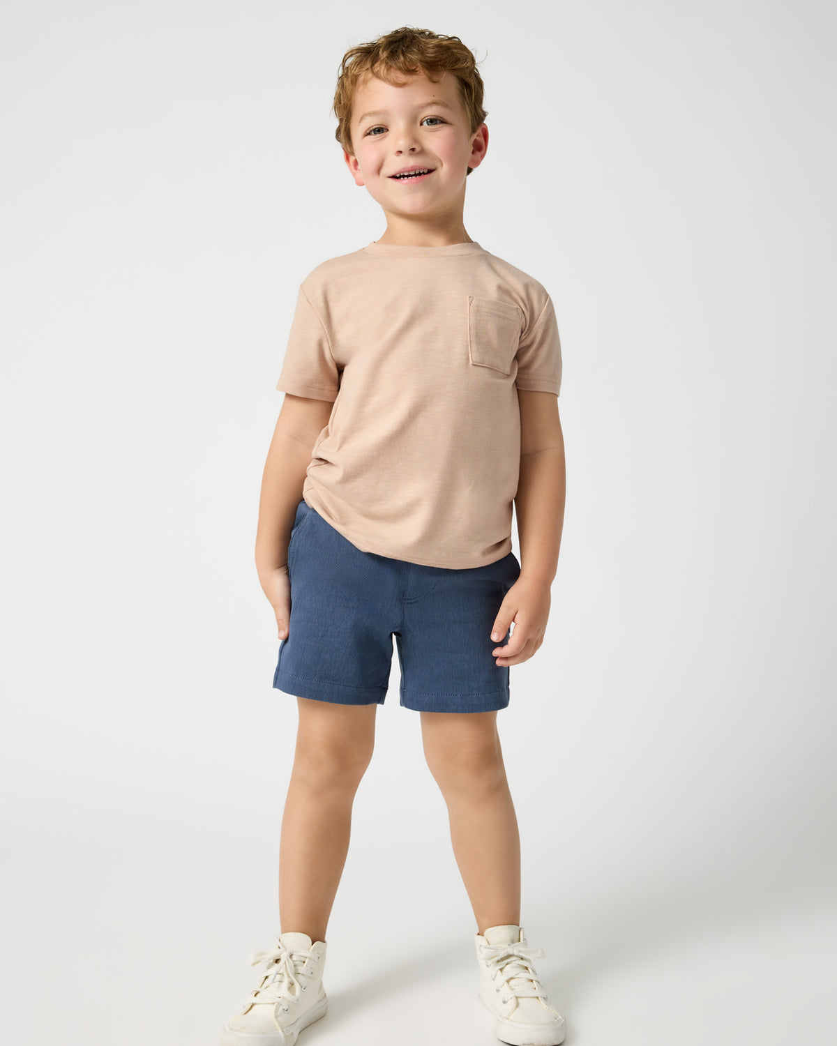 Boy wearing the Vintage Navy Chino Shorts with a tan tee