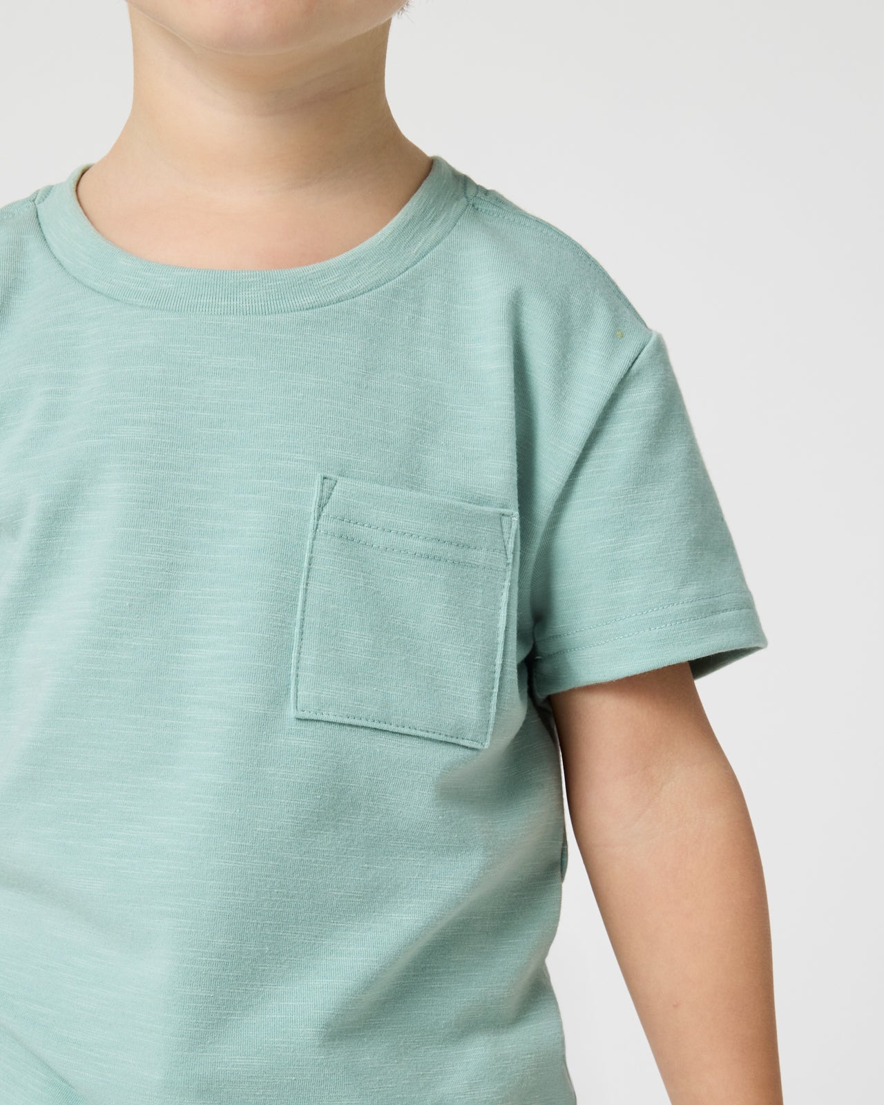 Close up of the pocket detail on the Aqua Surf Relaxed Pocket Tee