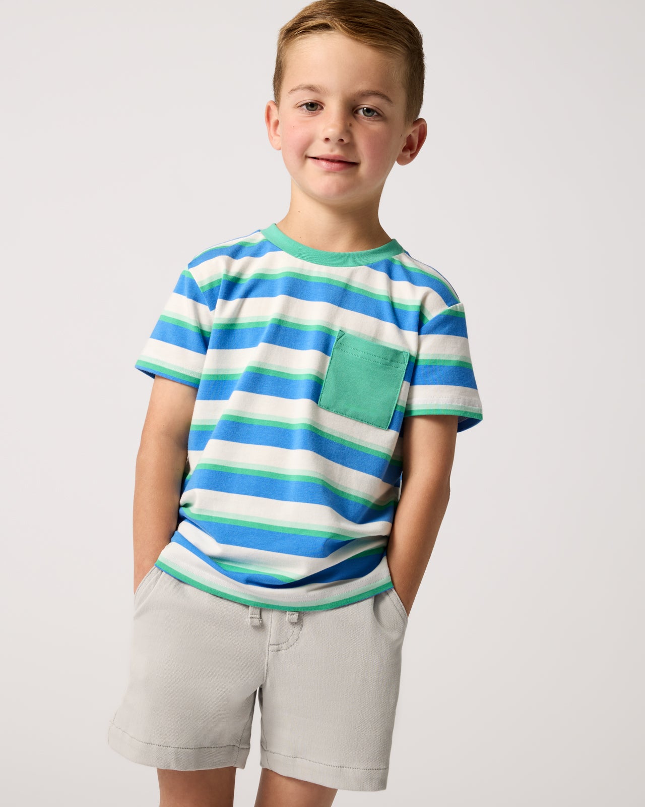 Boy wearing the Blue Bolt Stripes Relaxed Pocket Tee with gray shorts